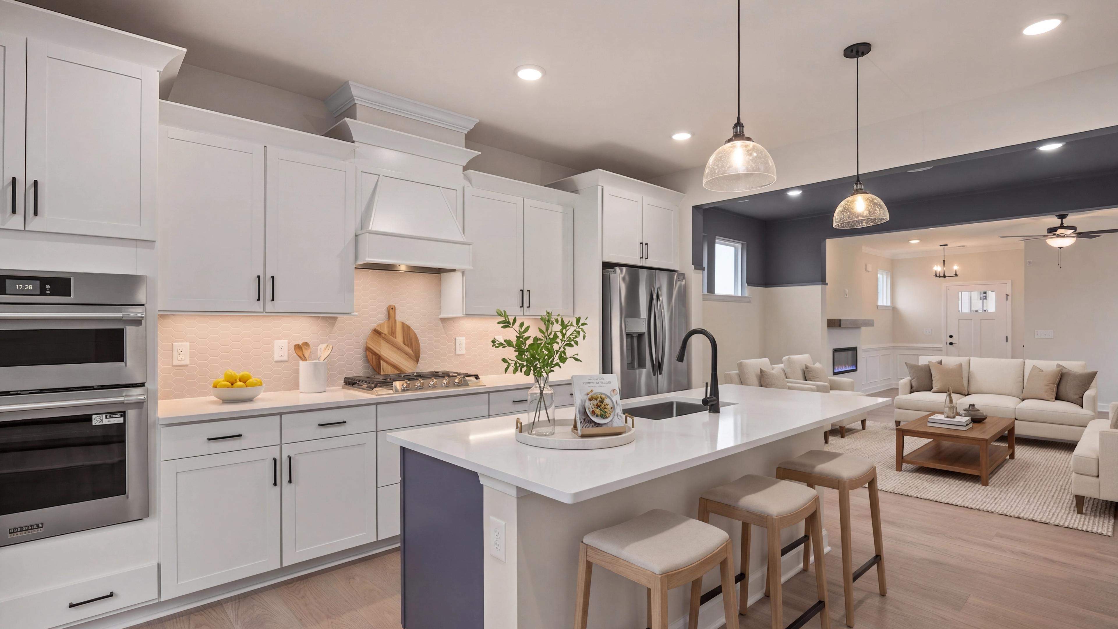 Spacious white kitchen with quartz island, stainless appliances, and French doors at Forestville Yard in Knightdale NC