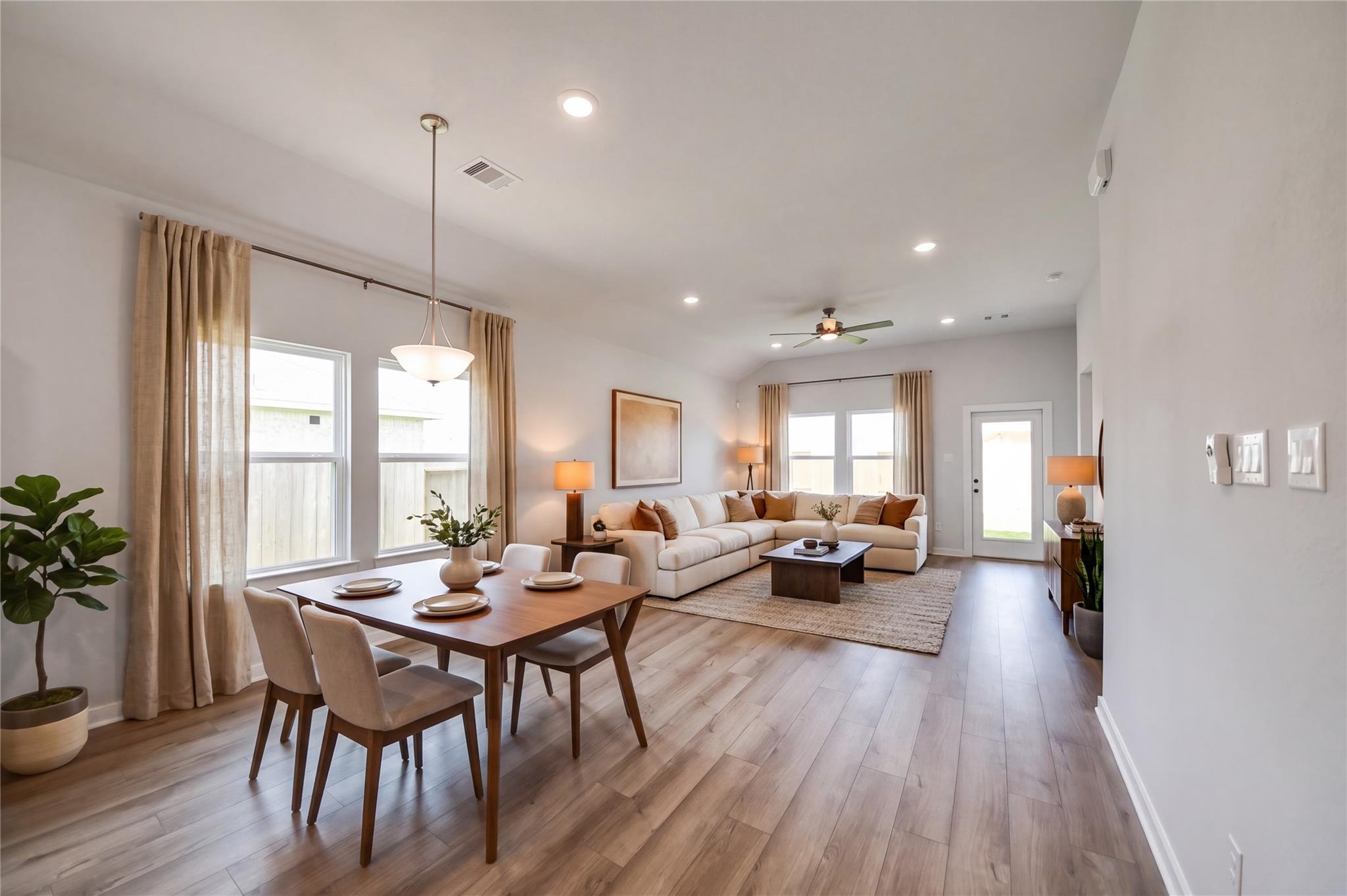 Open-concept dining and living area in The Riviera C floor plan at River Ranch Meadows, Dayton, Texas.
