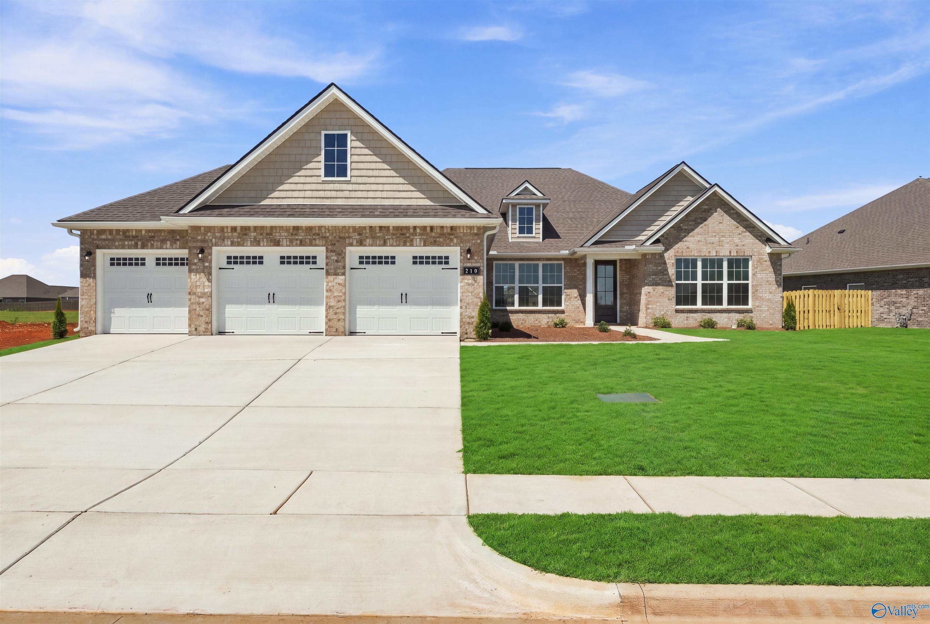 The Oxford floor plan by Davidson Homes: 1-story brick exterior with 3-car garage in Kendall Farms, Toney, Alabama.