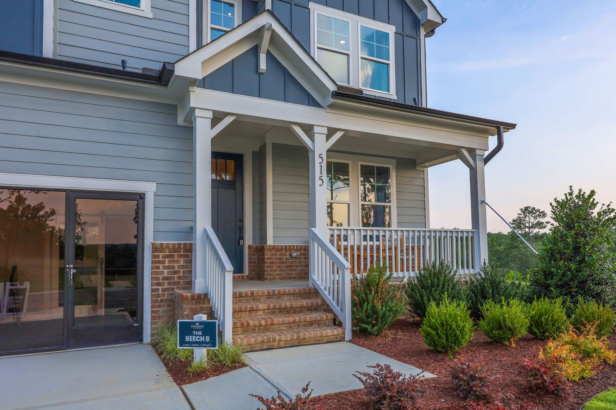 Craftsman-style exterior of The Beech B single-family home by Davidson Homes featuring a covered front porch and brick base.
