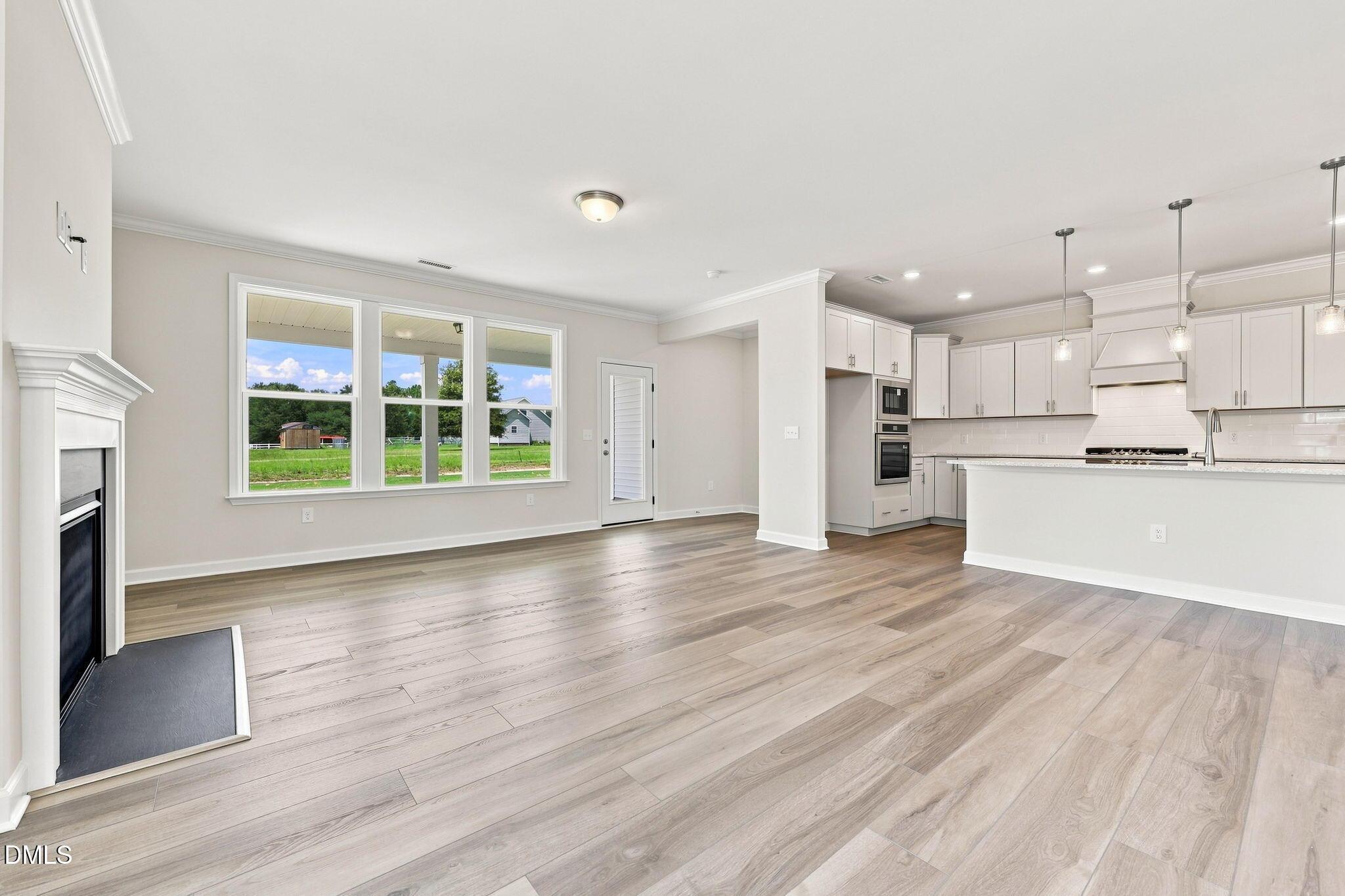Open-concept living room and kitchen in The Magnolia B floor plan at Retreat at North Main in Lillington, North Carolina.