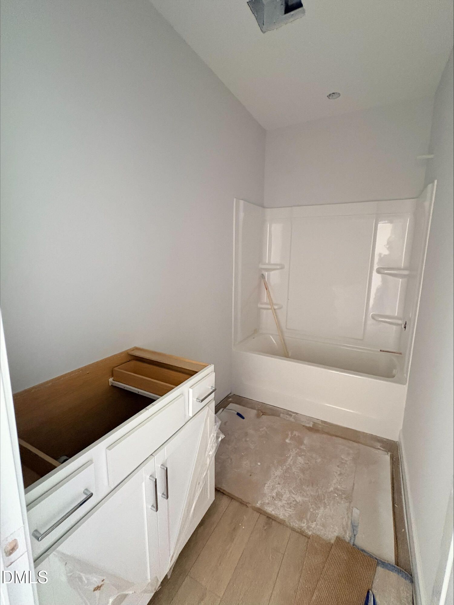 Bathroom under construction with white vanity and tub-shower combo in The Daphne D floor plan at Woodland Crossing, Zebulon.