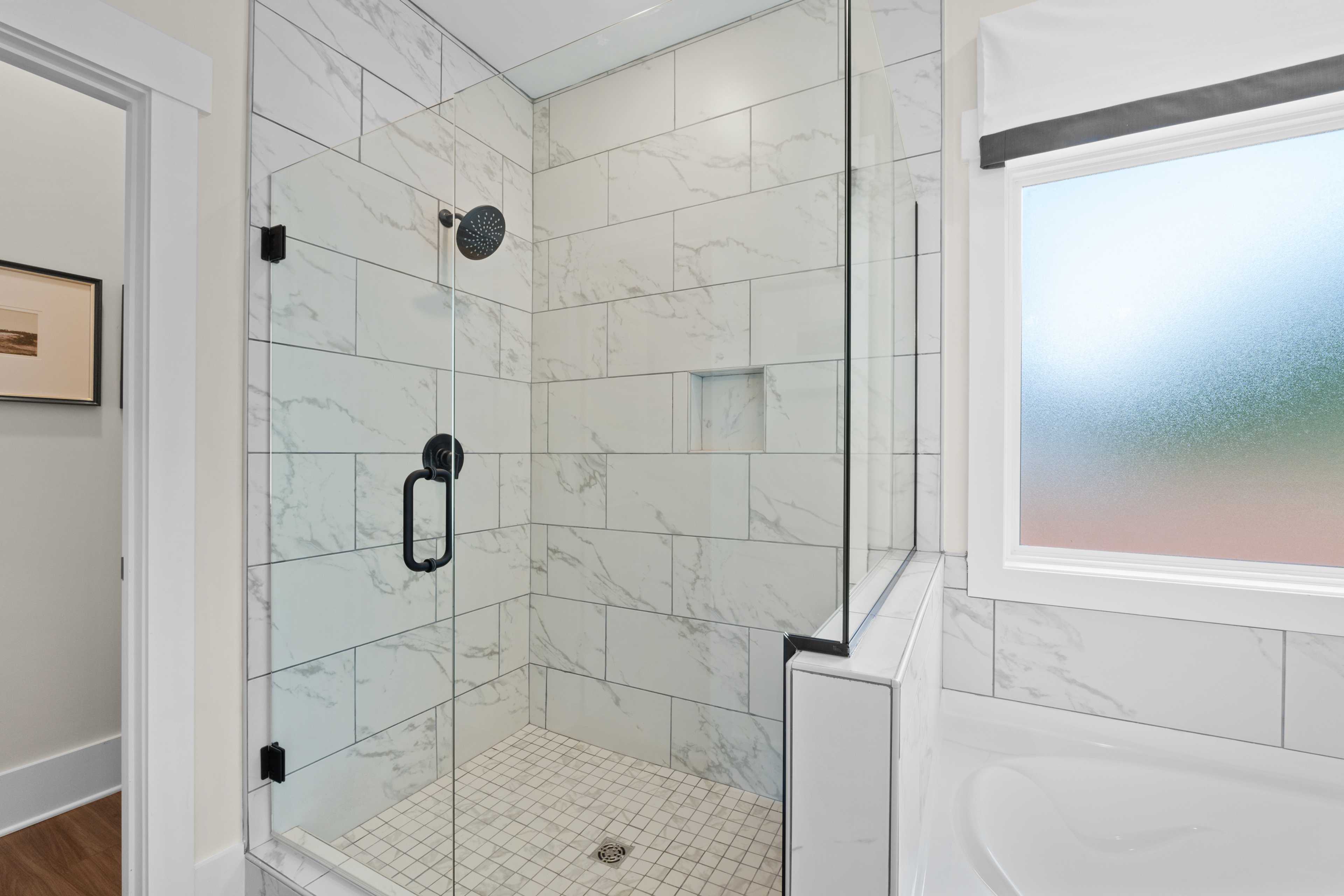 Spacious walk-in shower with white subway tiles and rainfall showerhead in Ivy Hills home, Toney Alabama by Davidson Homes