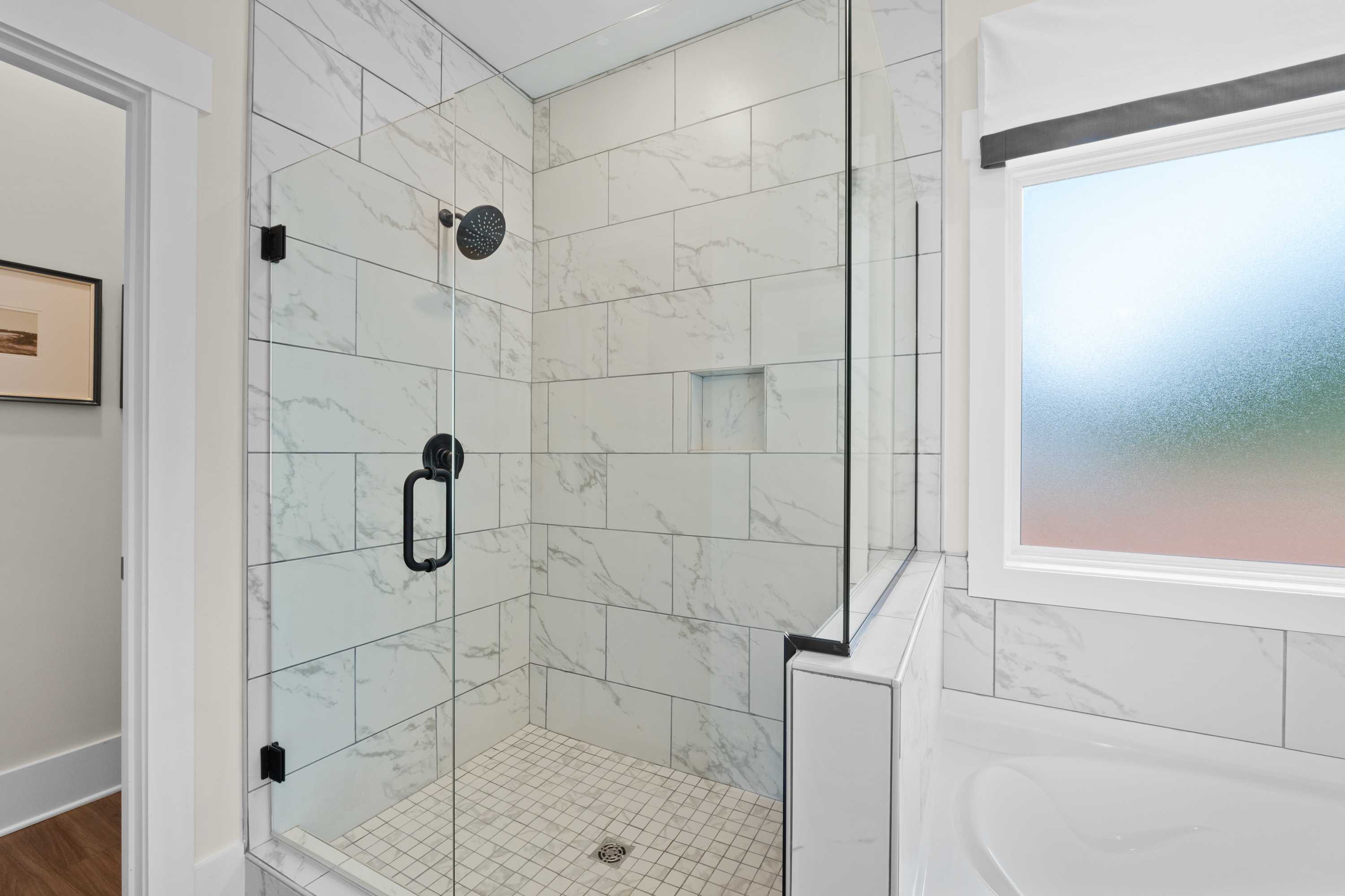 Spacious walk-in shower with white subway tiles and rainfall showerhead in Ivy Hills home, Toney Alabama by Davidson Homes