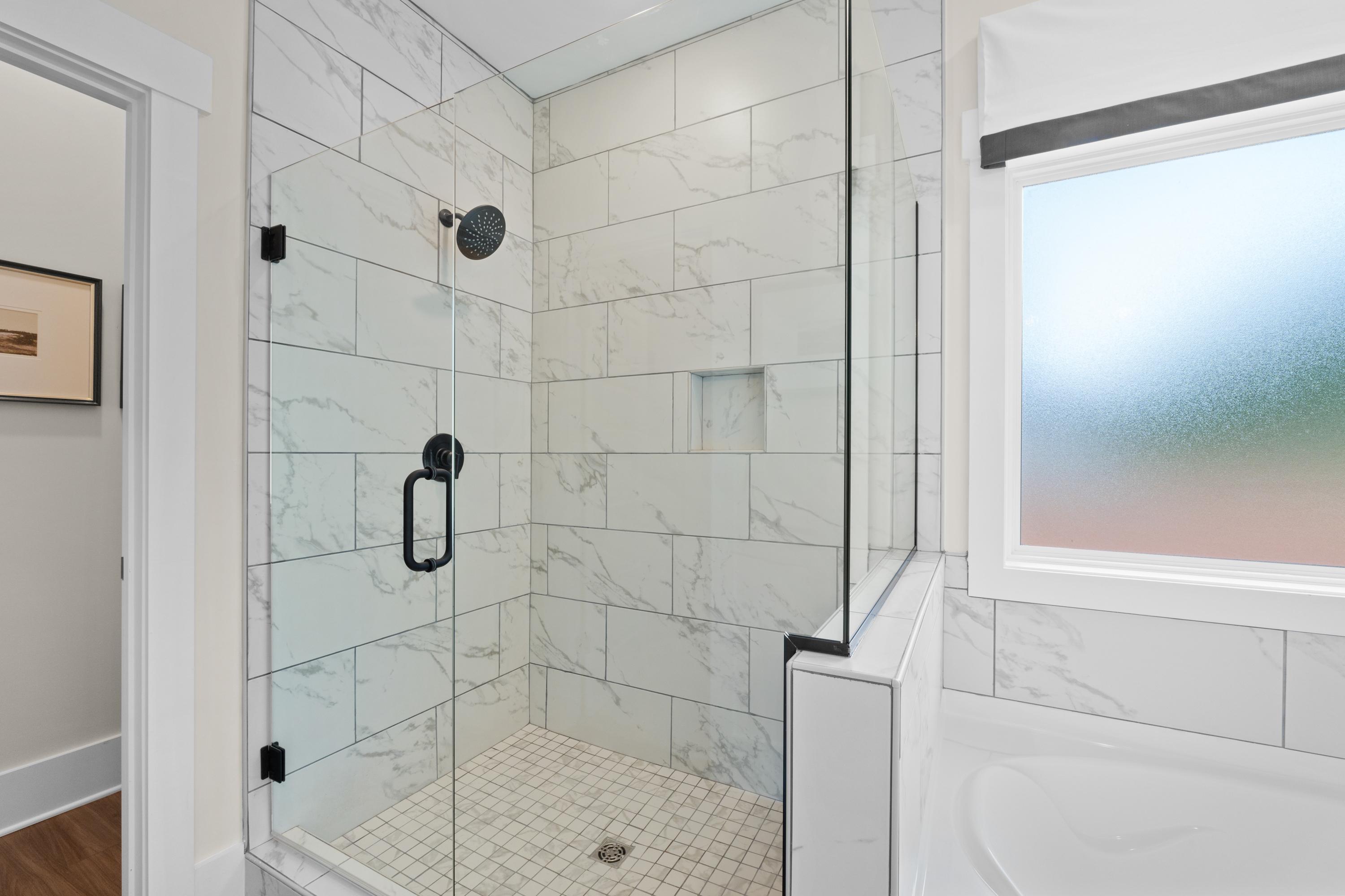 Spacious walk-in shower with white subway tiles and rainfall showerhead in Ivy Hills home, Toney Alabama by Davidson Homes