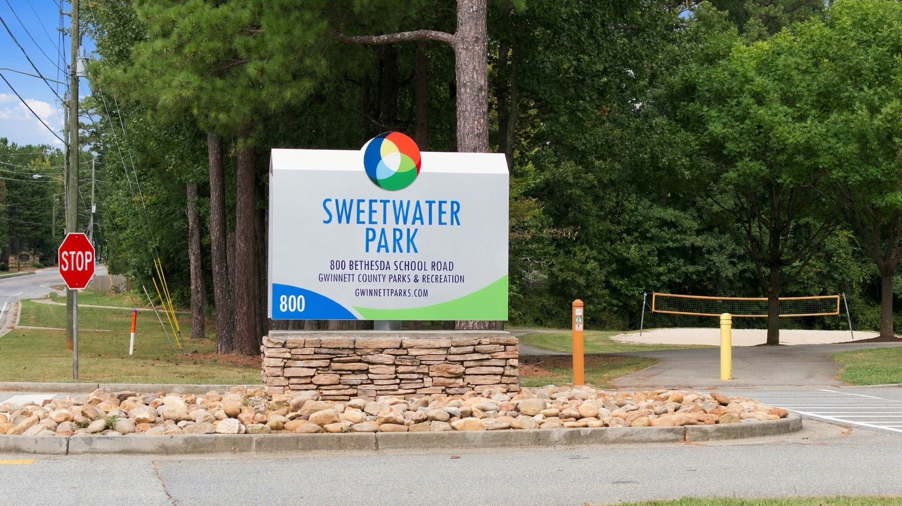 Entrance sign for Sweetwater Park in Gwinnett County near Alford at Bethesda, Lawrenceville GA, with stone base and landscaping