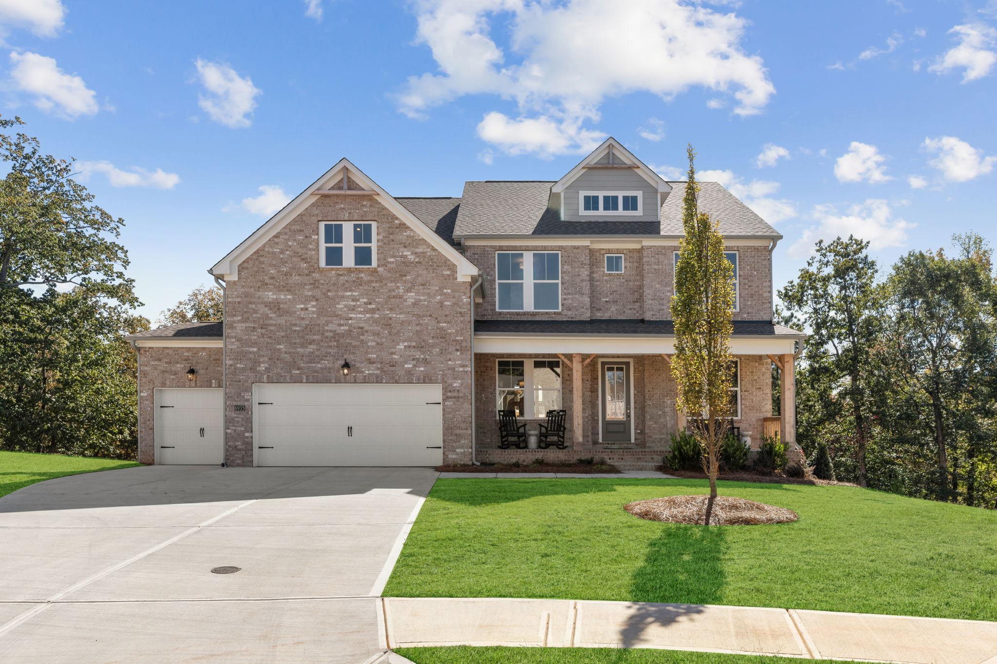 Front elevation exterior photo of the Danbury model home with 3-car garage and full brick exterior