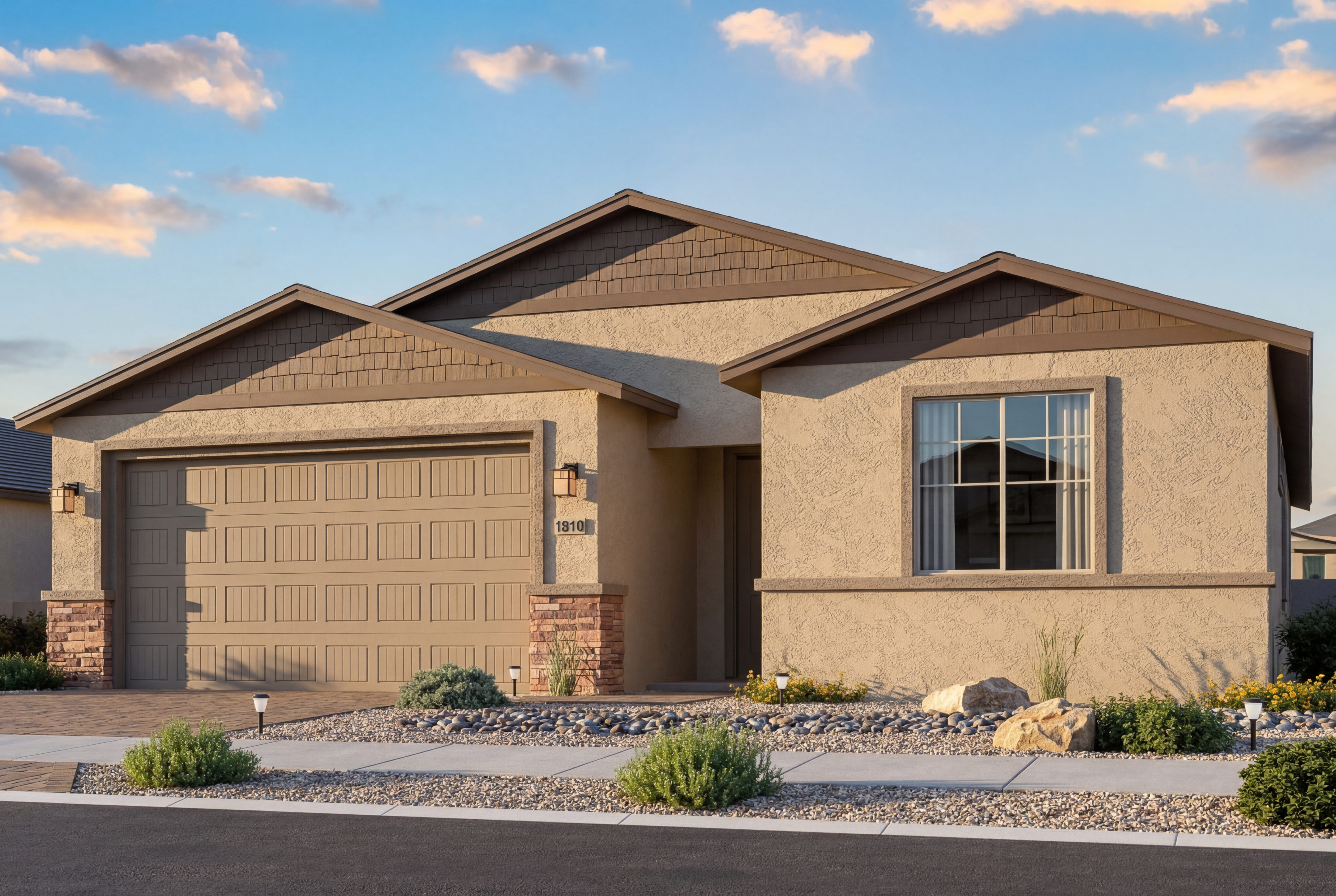 The Inspiration single-story home elevation featuring a 2-car garage, stucco exterior, and stone accents in Prescott Valley.
