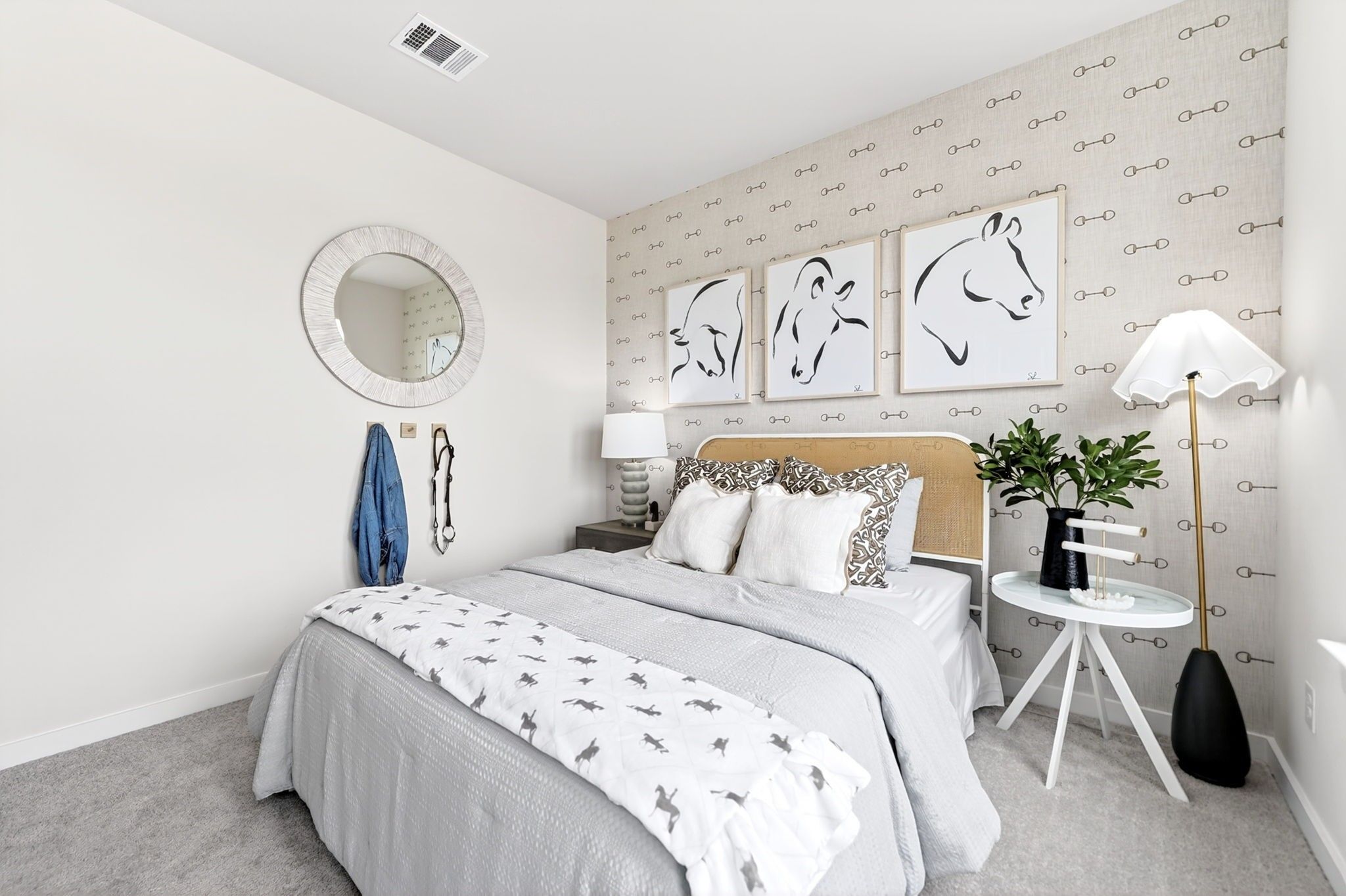 Cozy bedroom with equestrian-themed decor in The Laurel I floor plan by Davidson Homes in Heartland, Texas.