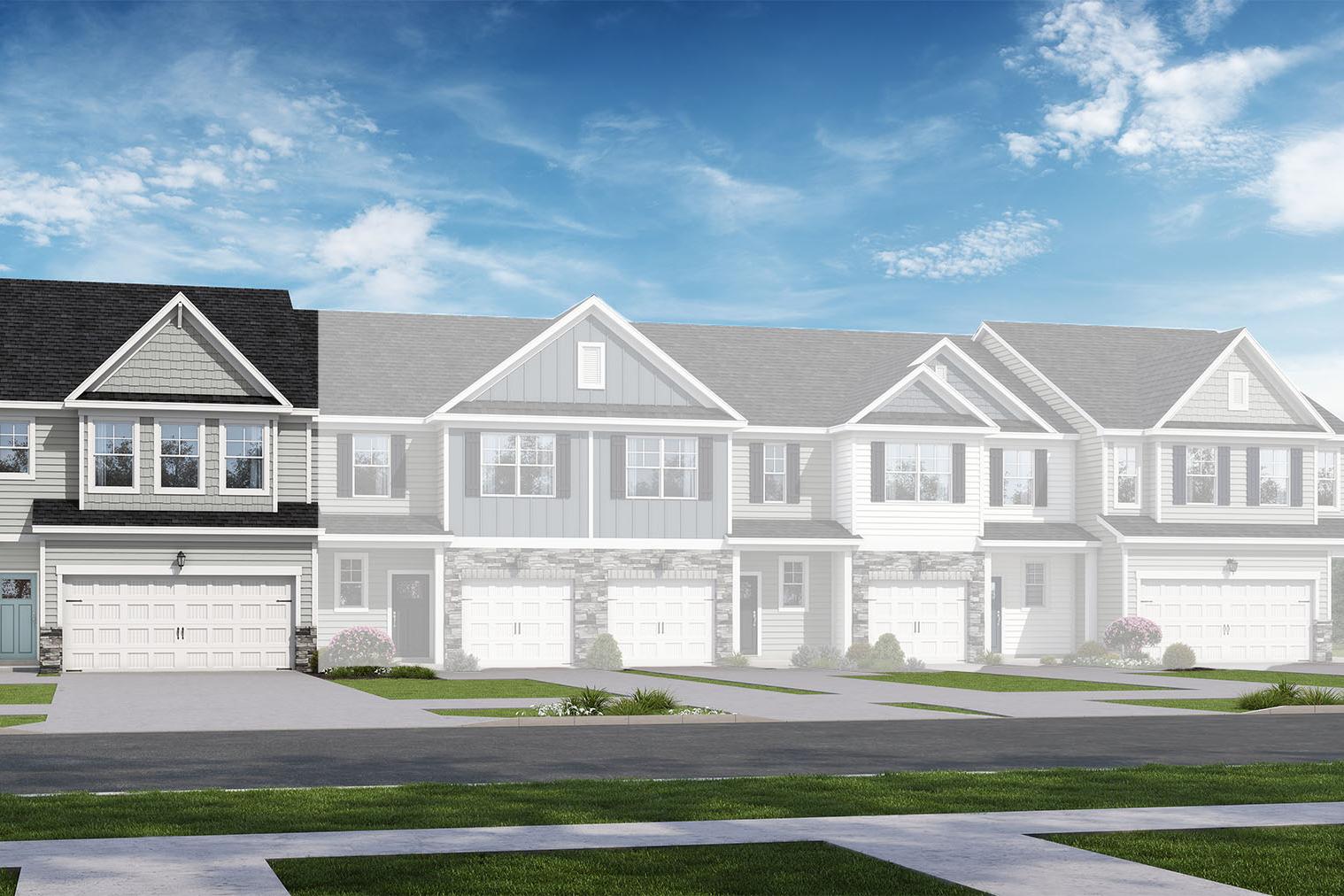 Two-story multi-family townhomes in The Wake design, gray siding exteriors, two-car garages, gabled roofs, blue sky and trees