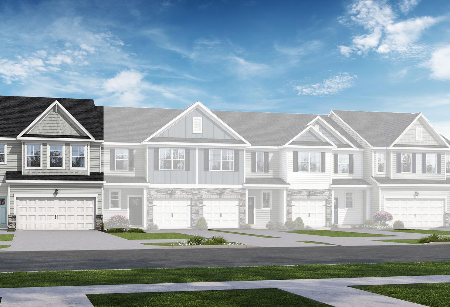 Two-story multi-family townhomes in The Wake design, gray siding exteriors, two-car garages, gabled roofs, blue sky and trees