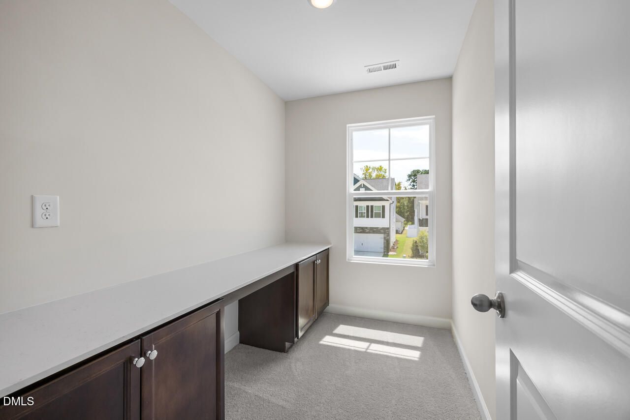 Bright home office or study nook with built-in desk in The Gavin A floor plan, Gregory Village, Lillington, North Carolina.