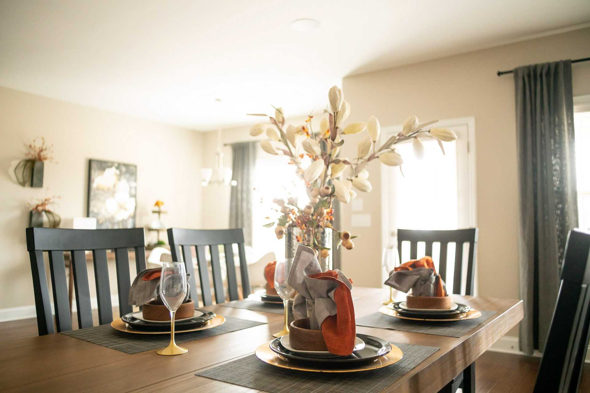 Dining room at Summer Pointe in Madison Alabama with wooden table set for fall meal, beige walls and large windows