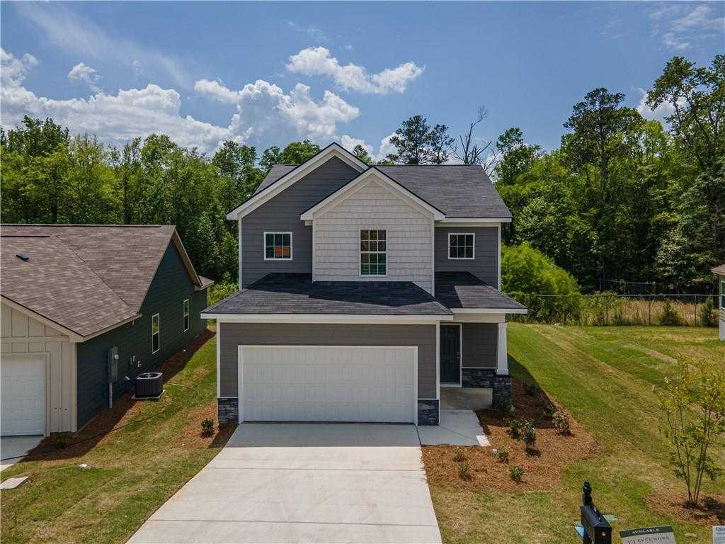 Modern 2-story gray home with 2-car garage, brick accents, and lush front yard in Summer Vineyard, Phenix City, Alabama