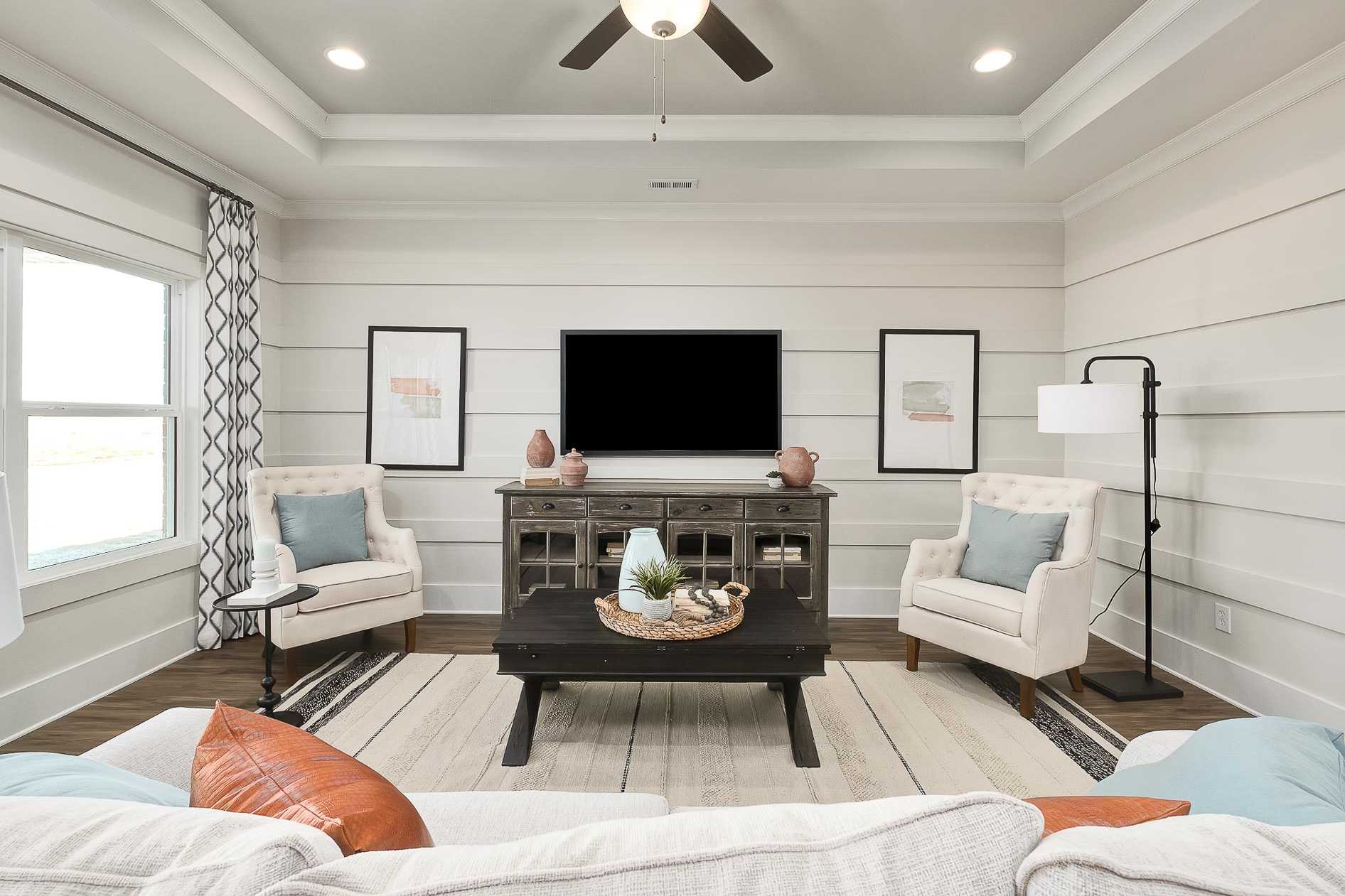 family room featuring tray ceiling