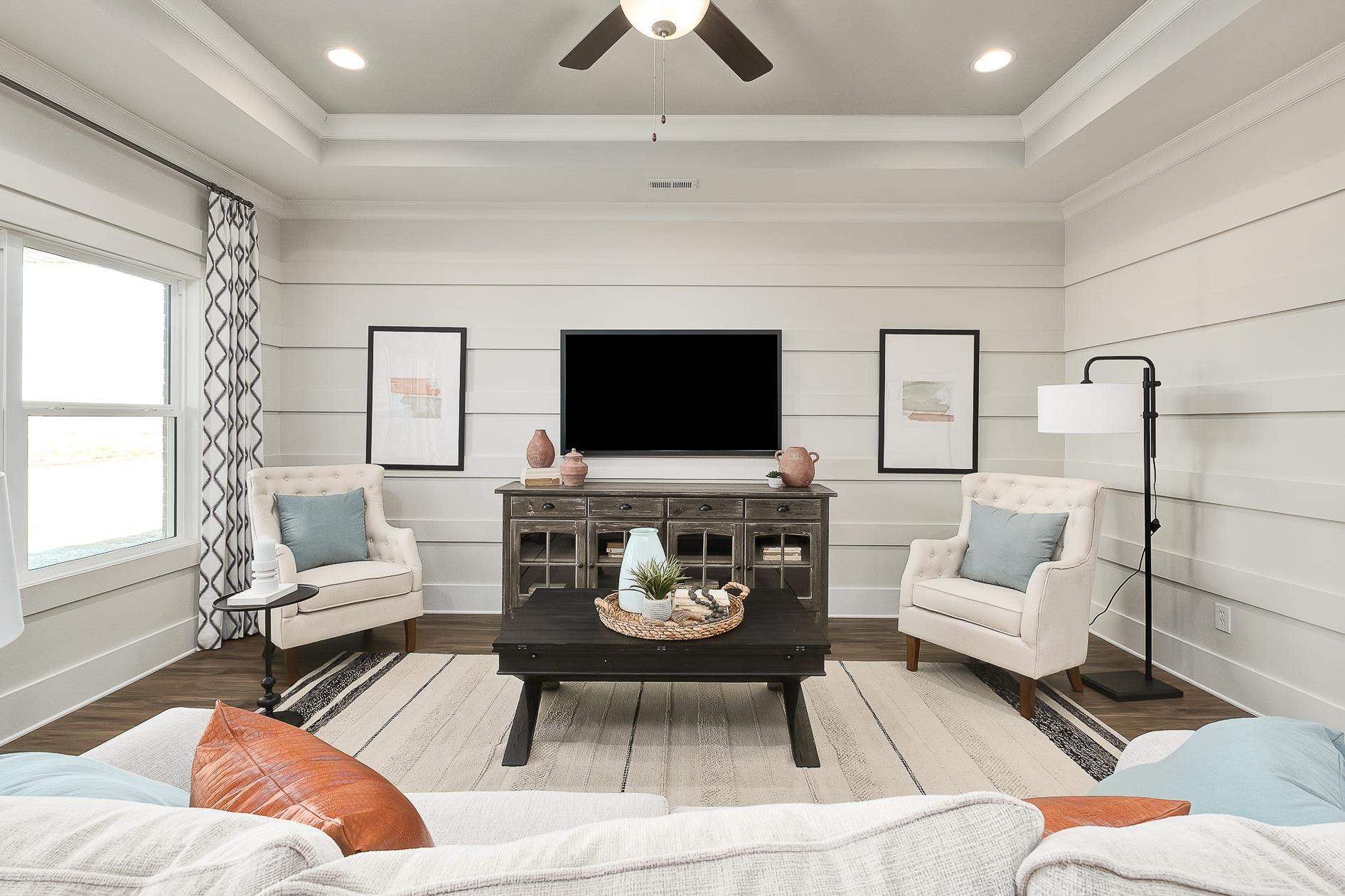 family room featuring tray ceiling