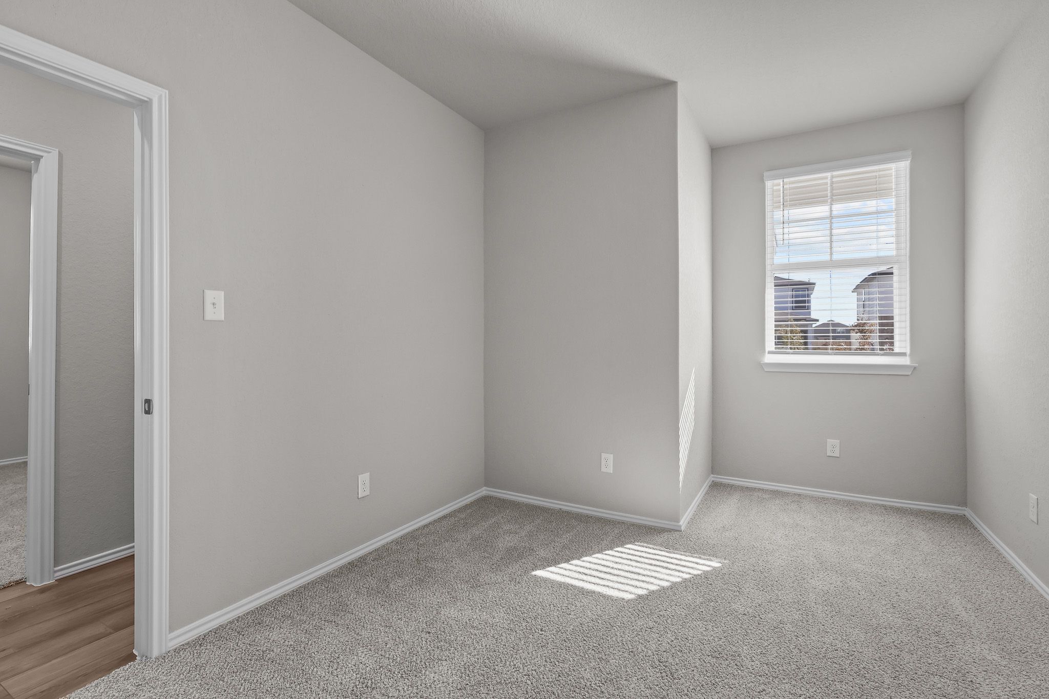 Bright secondary bedroom with plush carpeting in The Colorado floor plan by Davidson Homes in San Antonio, Texas.