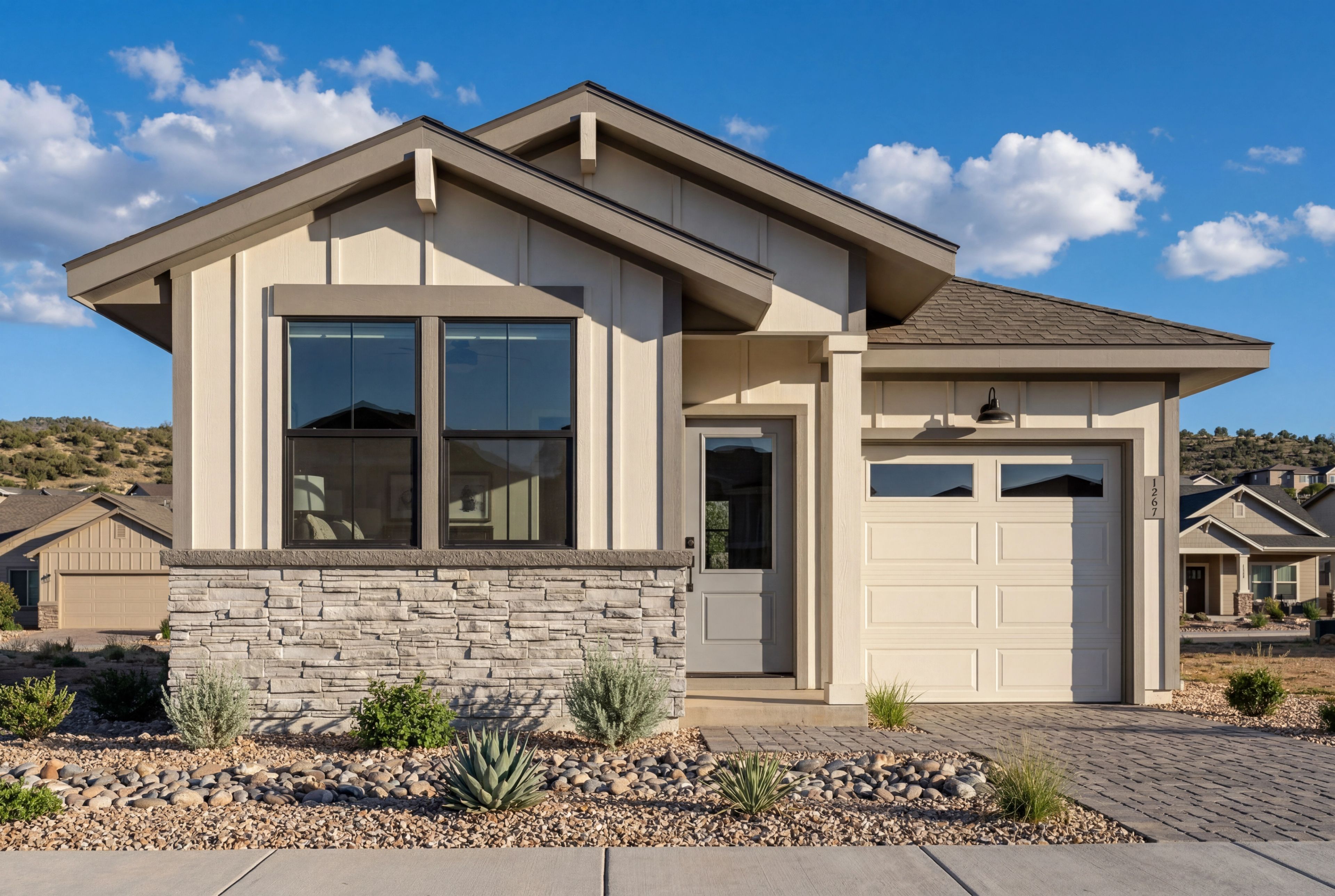 Modern single-story exterior of The Richmond B in Prescott, featuring stone accents, board-and-batten siding, and garage.