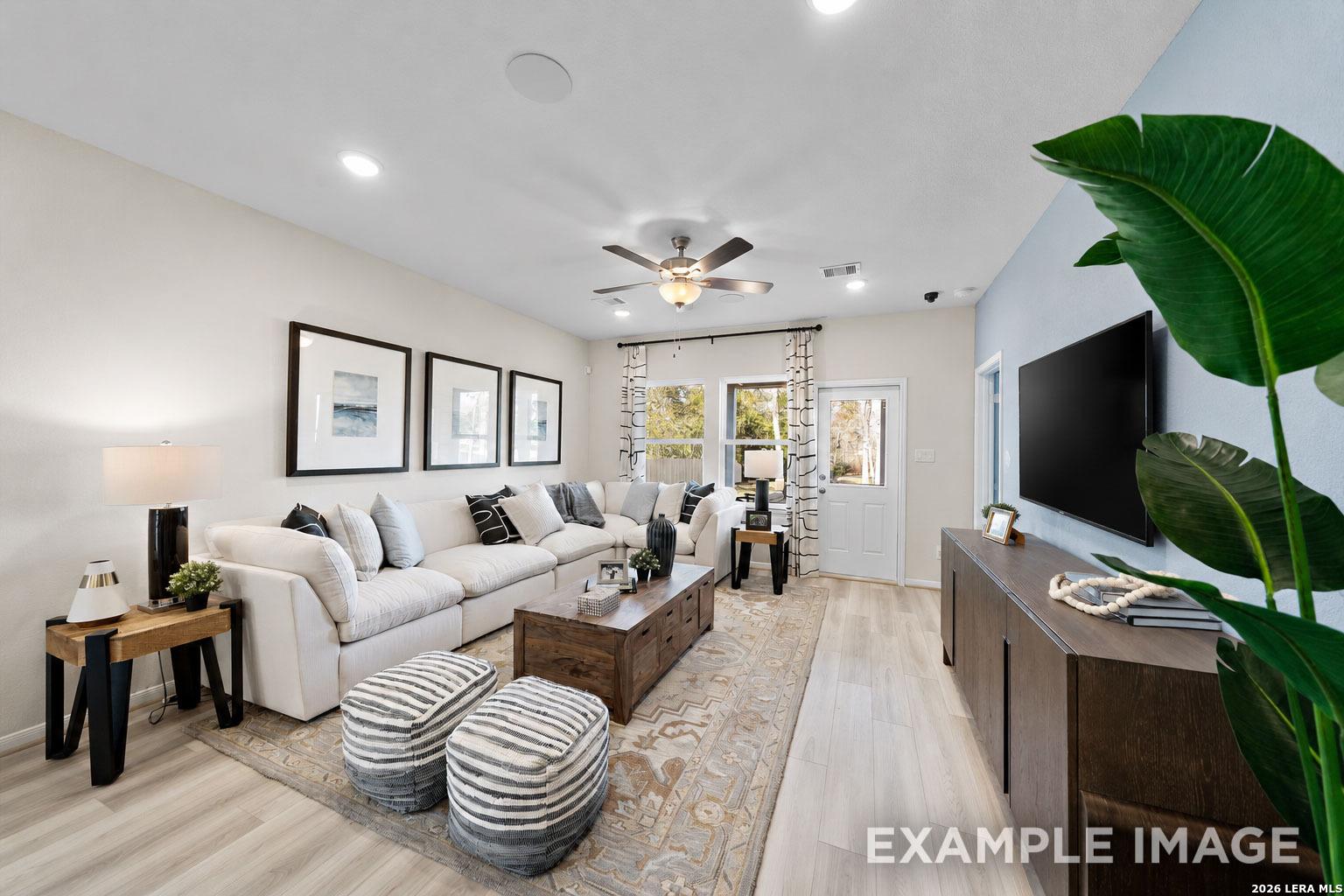 Modern living room with sectional sofa and wood coffee table in The San Marcos F floor plan, Rayburn Valley, San Antonio.