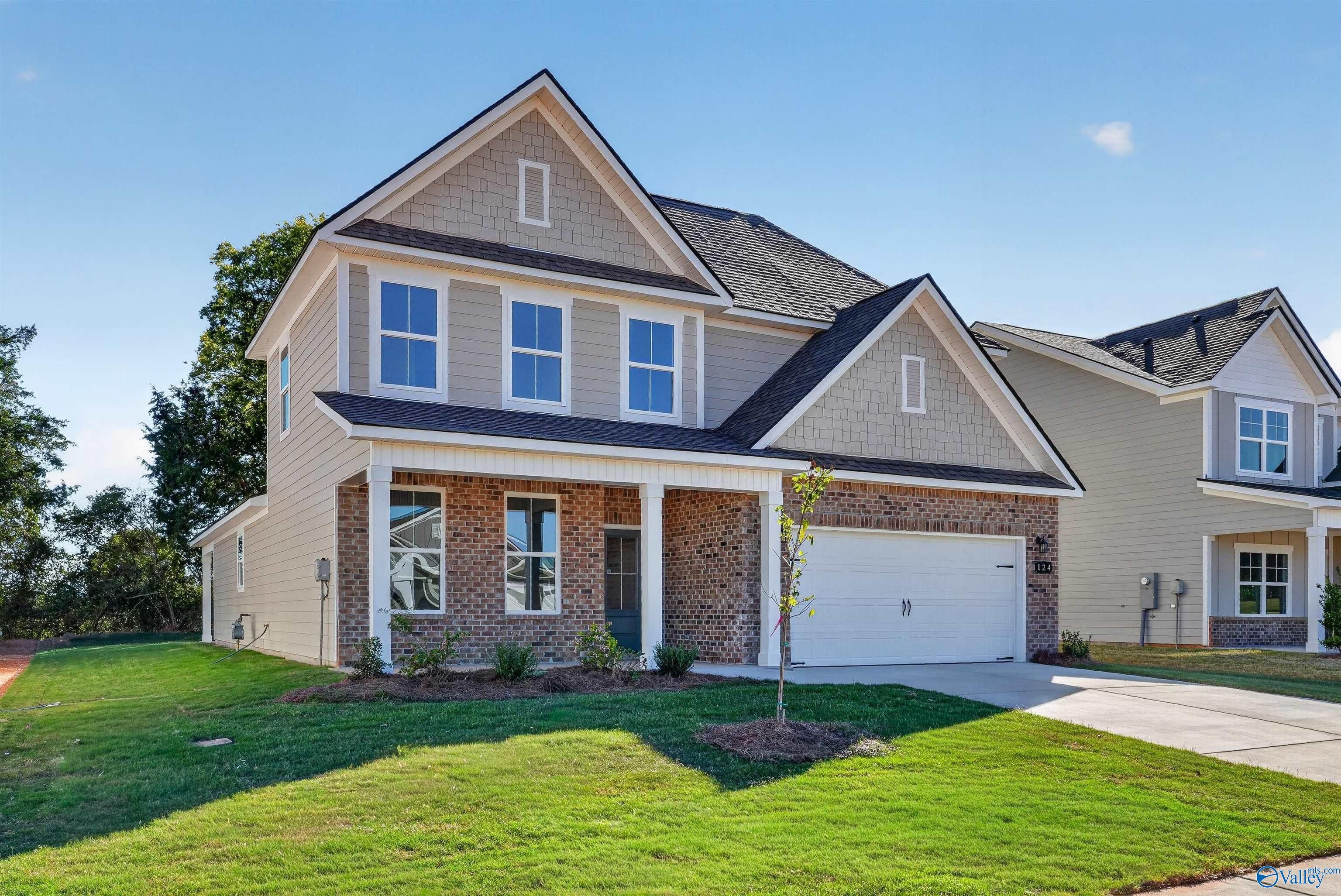 Two-story brick and siding home with covered front porch and 2-car garage at Berry Cove, New Market, Alabama by Davidson Homes