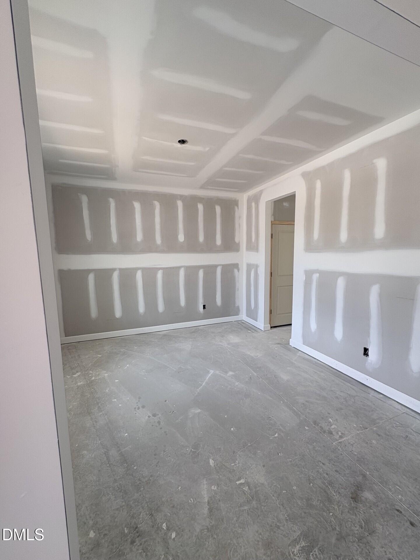 Unfinished bedroom under construction in The Ash C floor plan at Woodland Crossing in Zebulon, North Carolina.