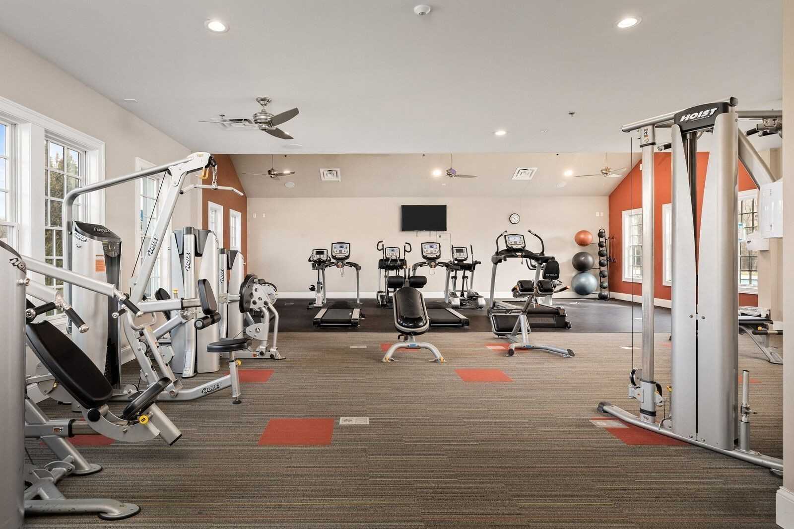 Modern fitness room with treadmills, ellipticals, weights in Davidson Homes The Ridgeport, Carellton, Gallatin, TN
