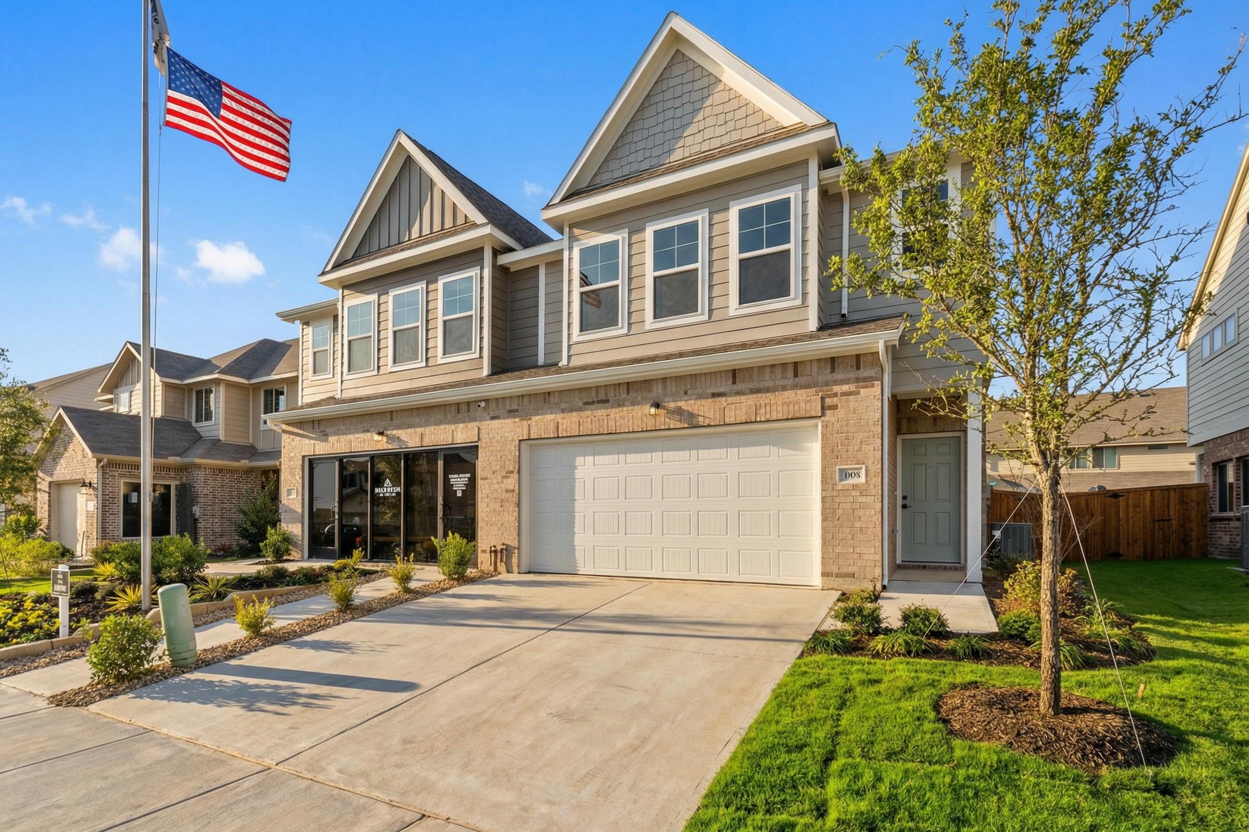 Modern two-story home exterior at Lake Park Villas in Wylie Texas with gabled roof brick accents American flag and landscaped driveway