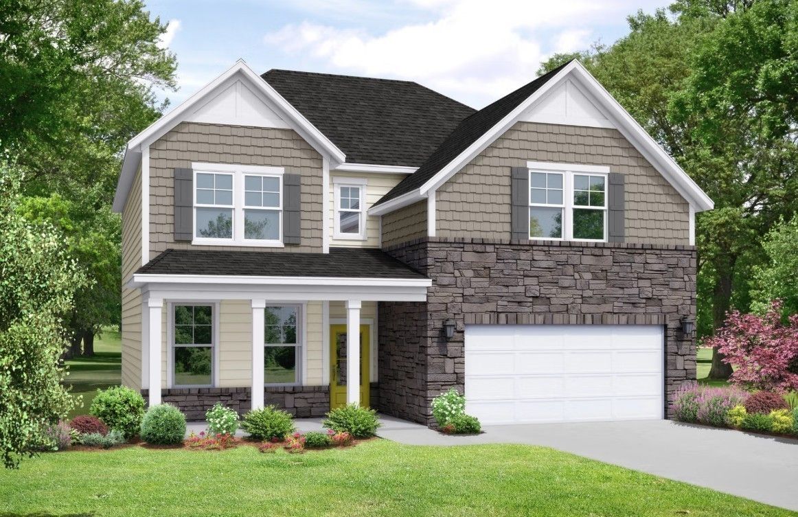 Two-story Willow floor plan home by Davidson Homes featuring stone accents, covered porch, yellow door, and two-car garage in Woods Crossing, Gallatin, TN