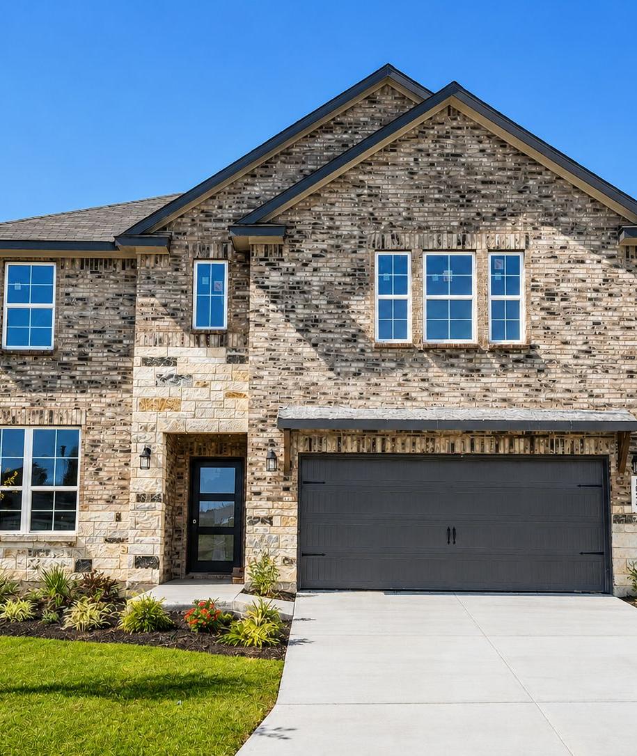 Two-story brick and stone home exterior by Davidson Homes at Bricewood in San Antonio, TX with a two-car garage.