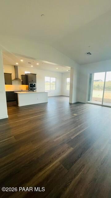 Open-concept kitchen and living area with hardwood floors in The Aurea C floor plan at Hidden Hills, Prescott, Arizona.