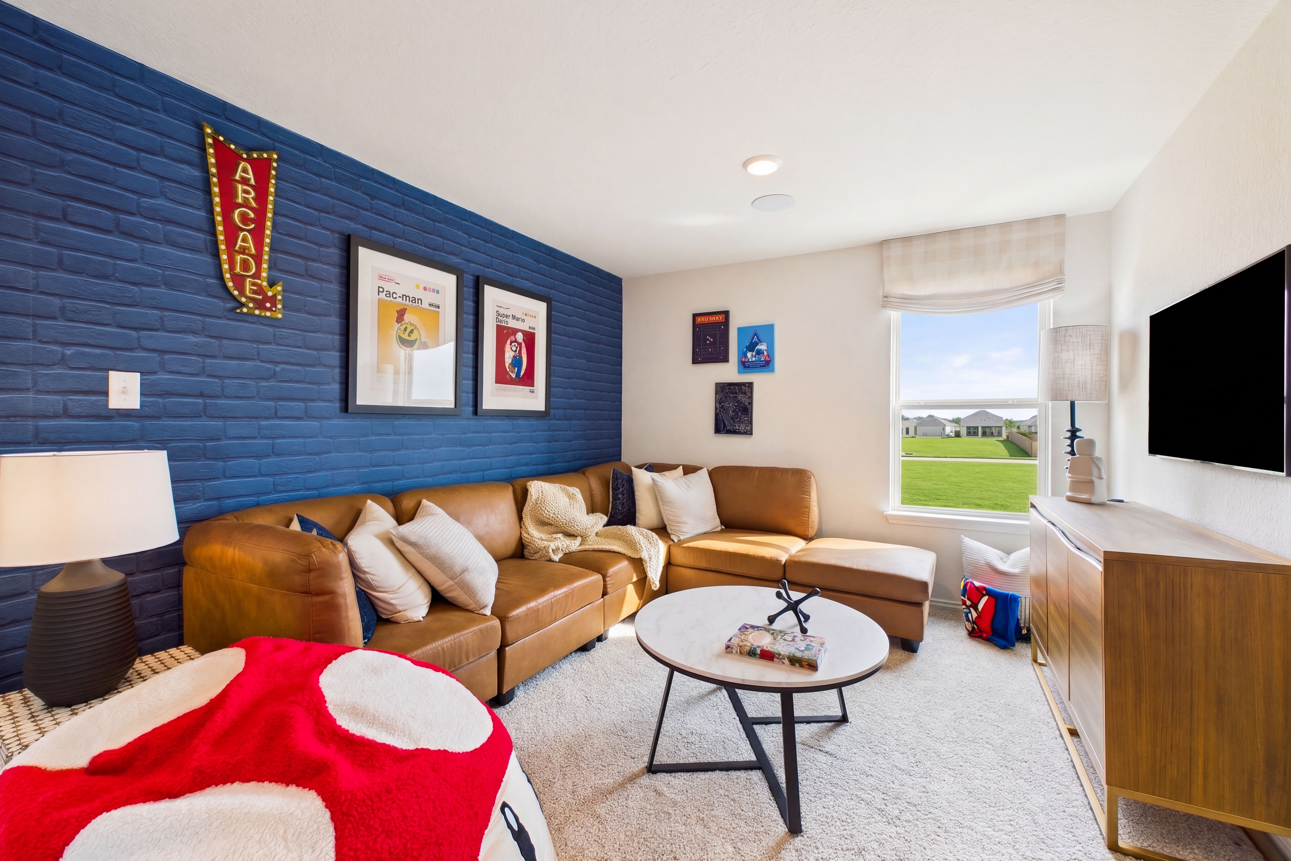 Loft room with cozy seating and blue accent wall, located in San Antonio, TX