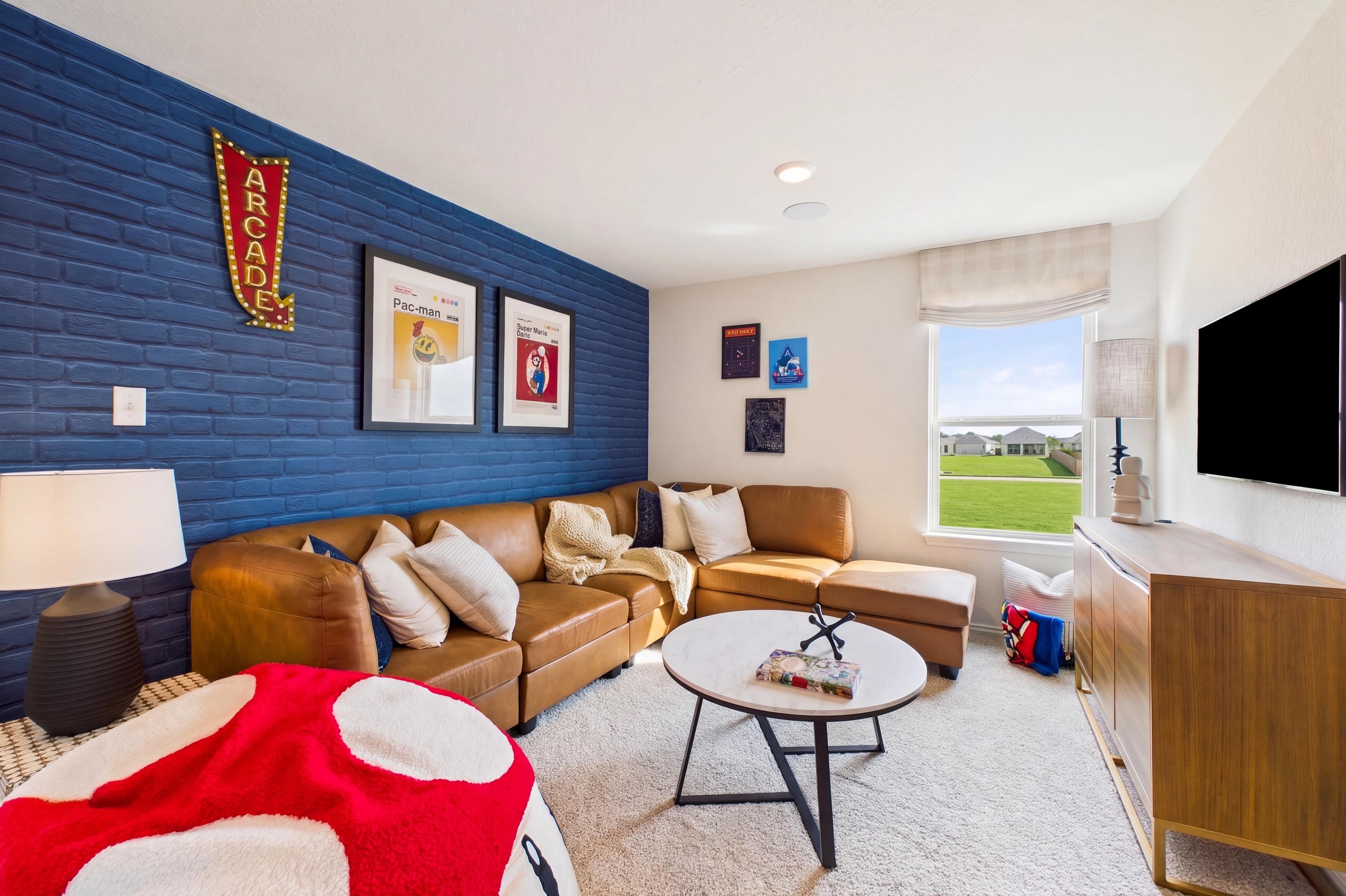 Loft room with cozy seating and blue accent wall, located in San Antonio, TX