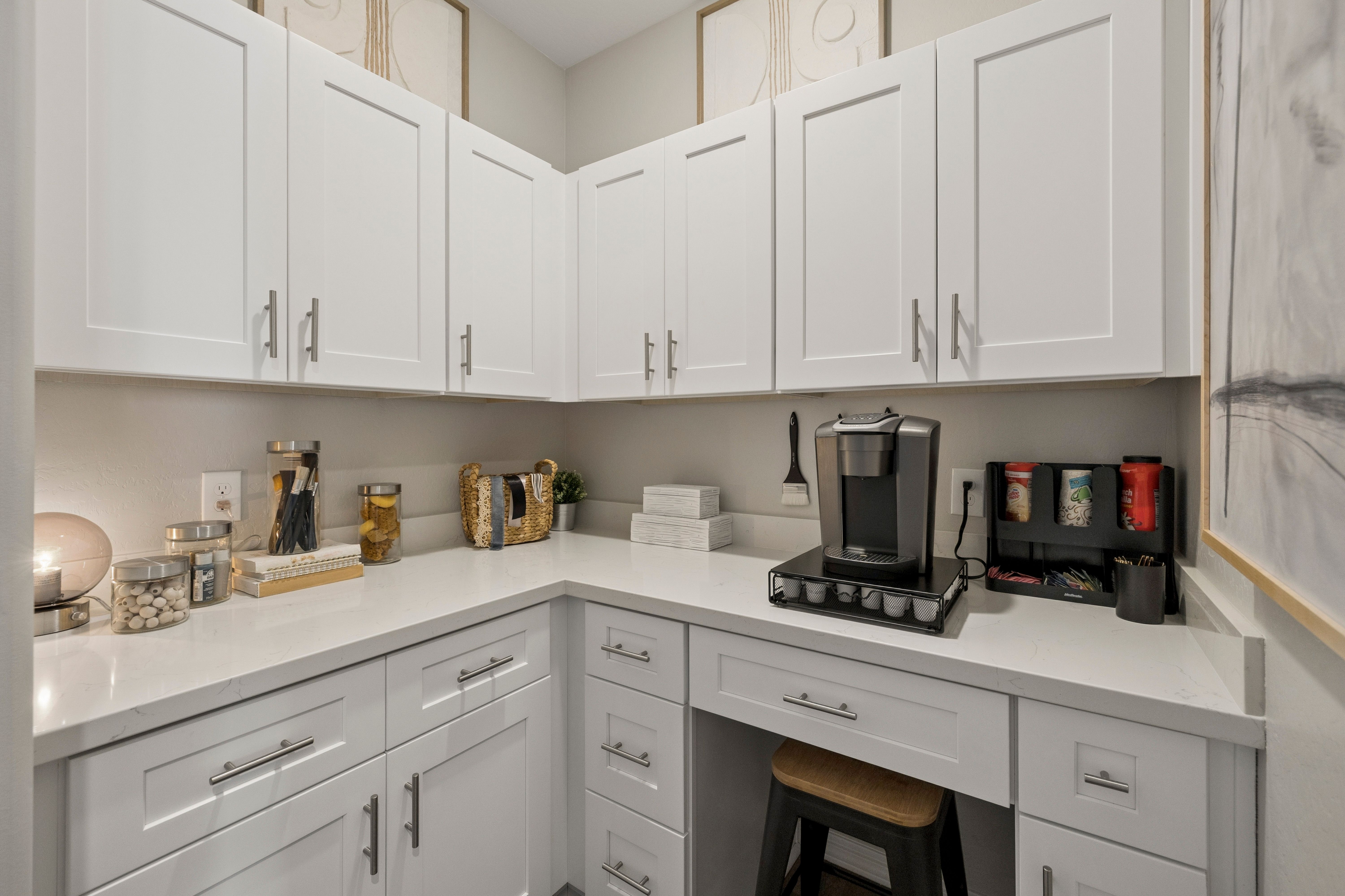 White shaker cabinets and quartz coffee nook at South Ranch Destination Collection in Prescott AZ with Keurig station and bar stool