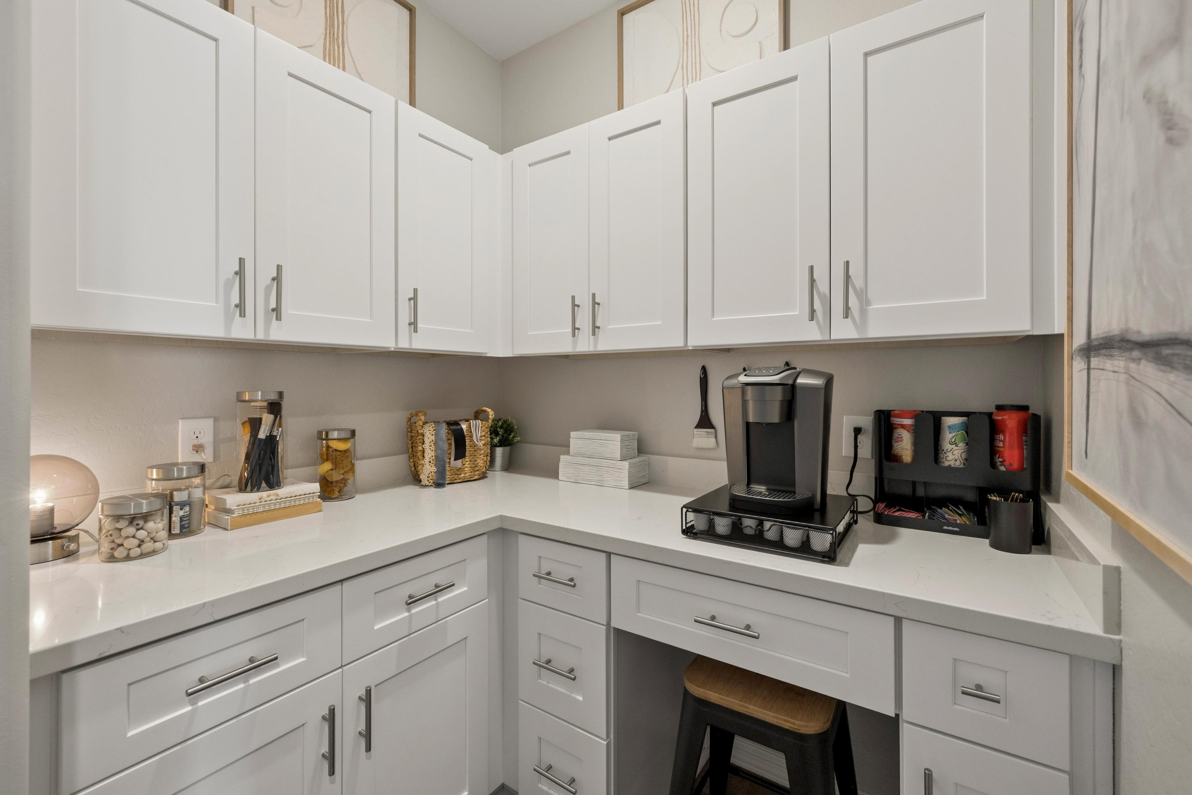 White shaker cabinets and quartz coffee nook at South Ranch Destination Collection in Prescott AZ with Keurig station and bar stool