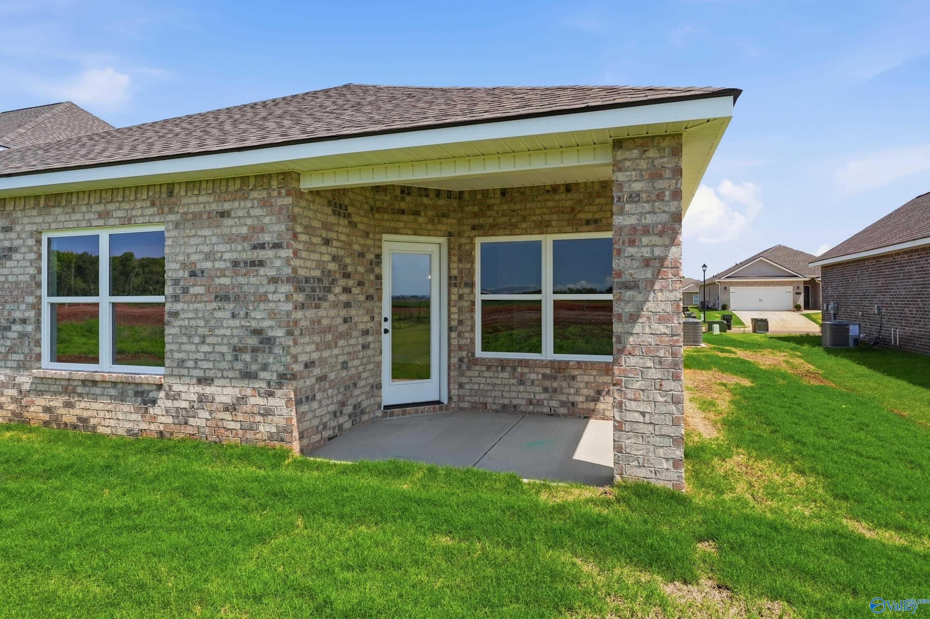 Brick exterior of The Daphne floor plan by Davidson Homes with covered back patio in Clearview, Hazel Green, Alabama.