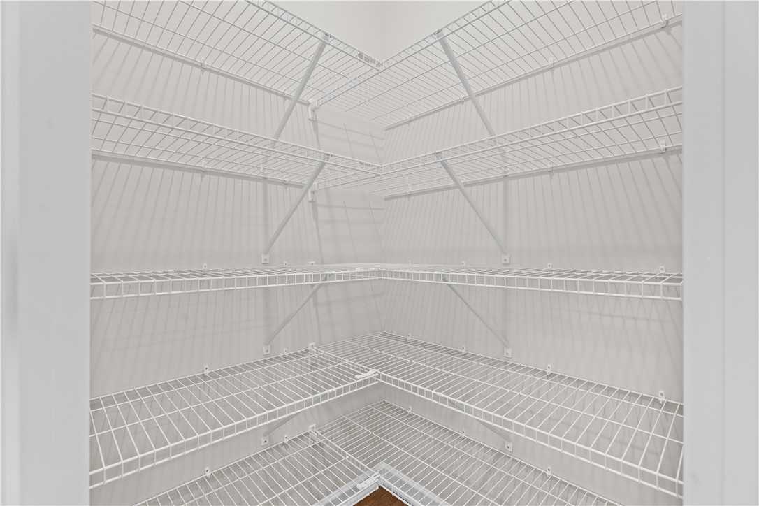 White wire shelving in corner pantry of 4-bedroom Evermore Homes The Orion in Silver Oak, Cusseta, Alabama