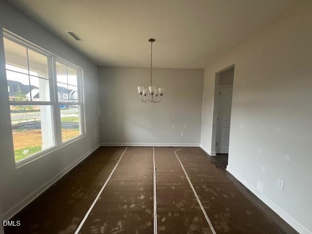 Bright dining room with chandelier in The Ash B floor plan at Retreat at North Main in Lillington, North Carolina.