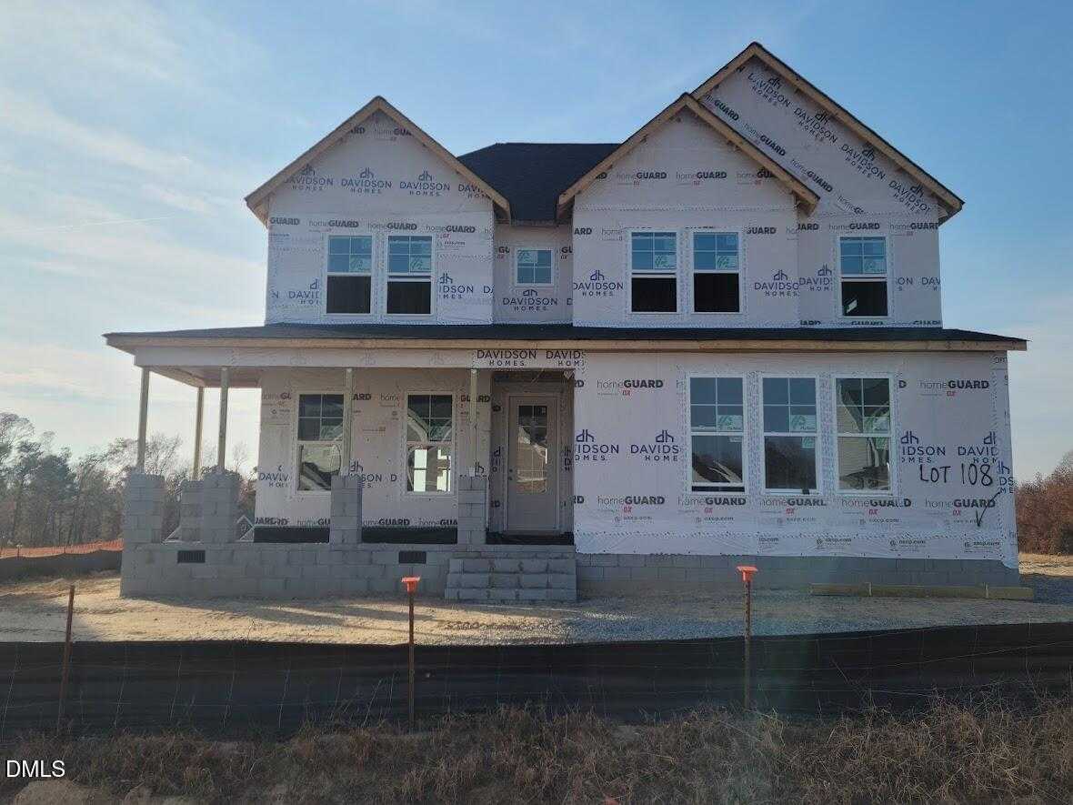 Two-story Davidson Homes Willow G under construction in Tobacco Road, Angier, NC, with front porch, garage, and sheathing