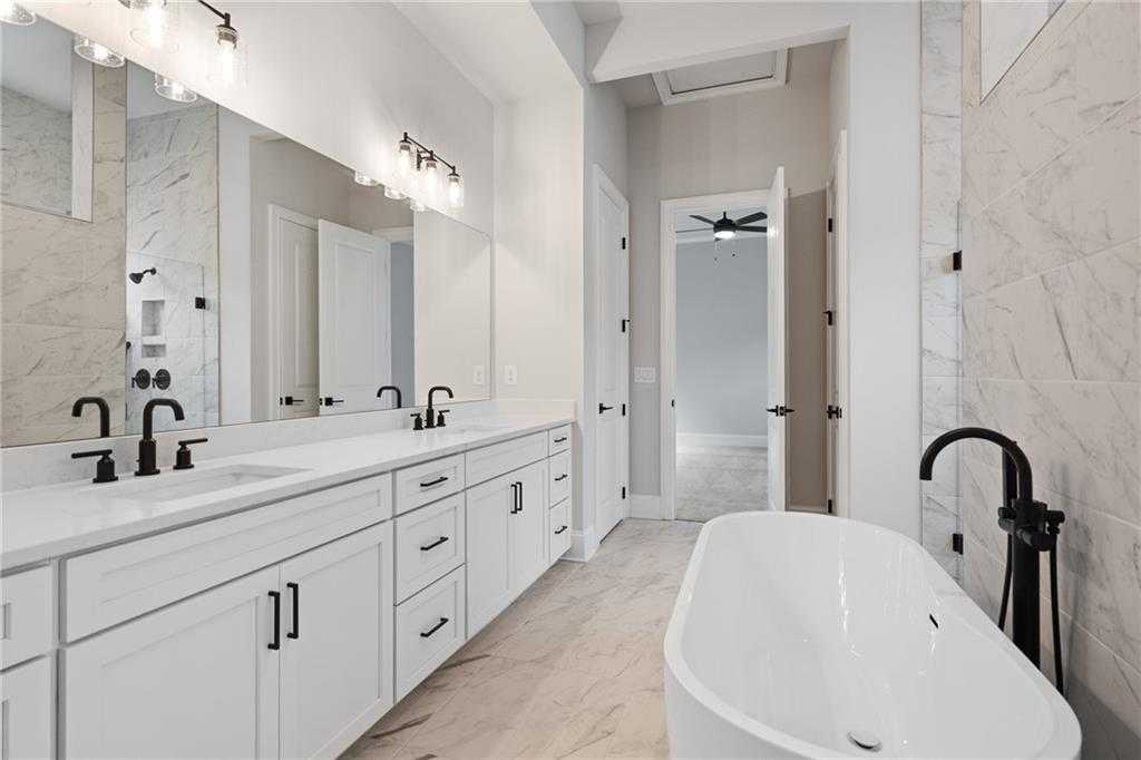 Luxurious master bath with double vanity, freestanding tub, marble counters in Davidson Homes The Seaside B, Woodstock, GA