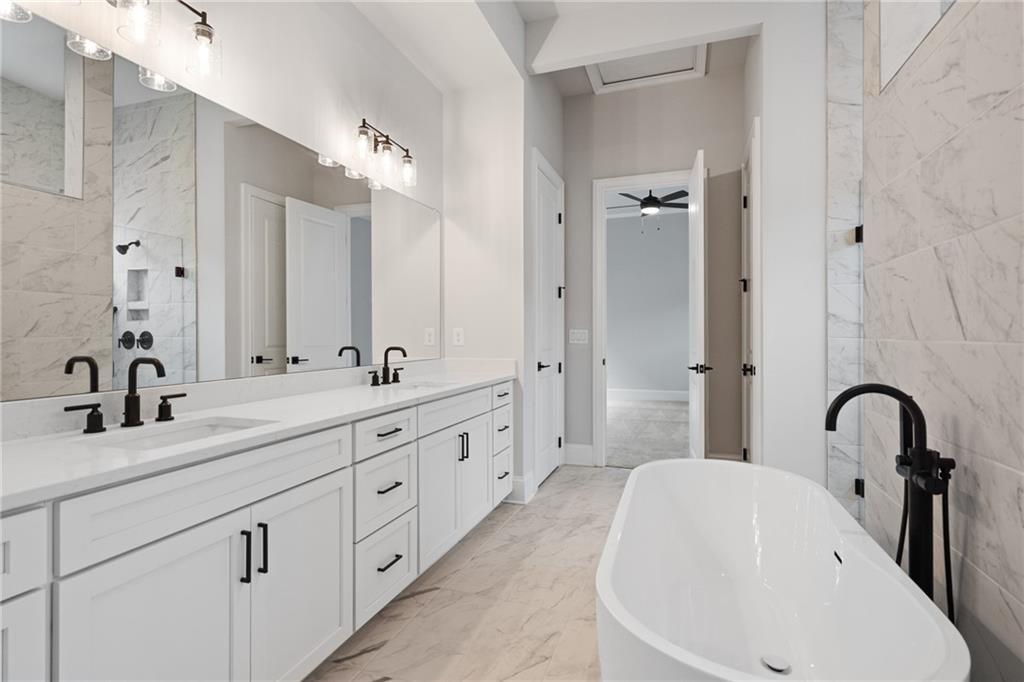 Luxurious master bath with double vanity, freestanding tub, marble counters in Davidson Homes The Seaside B, Woodstock, GA