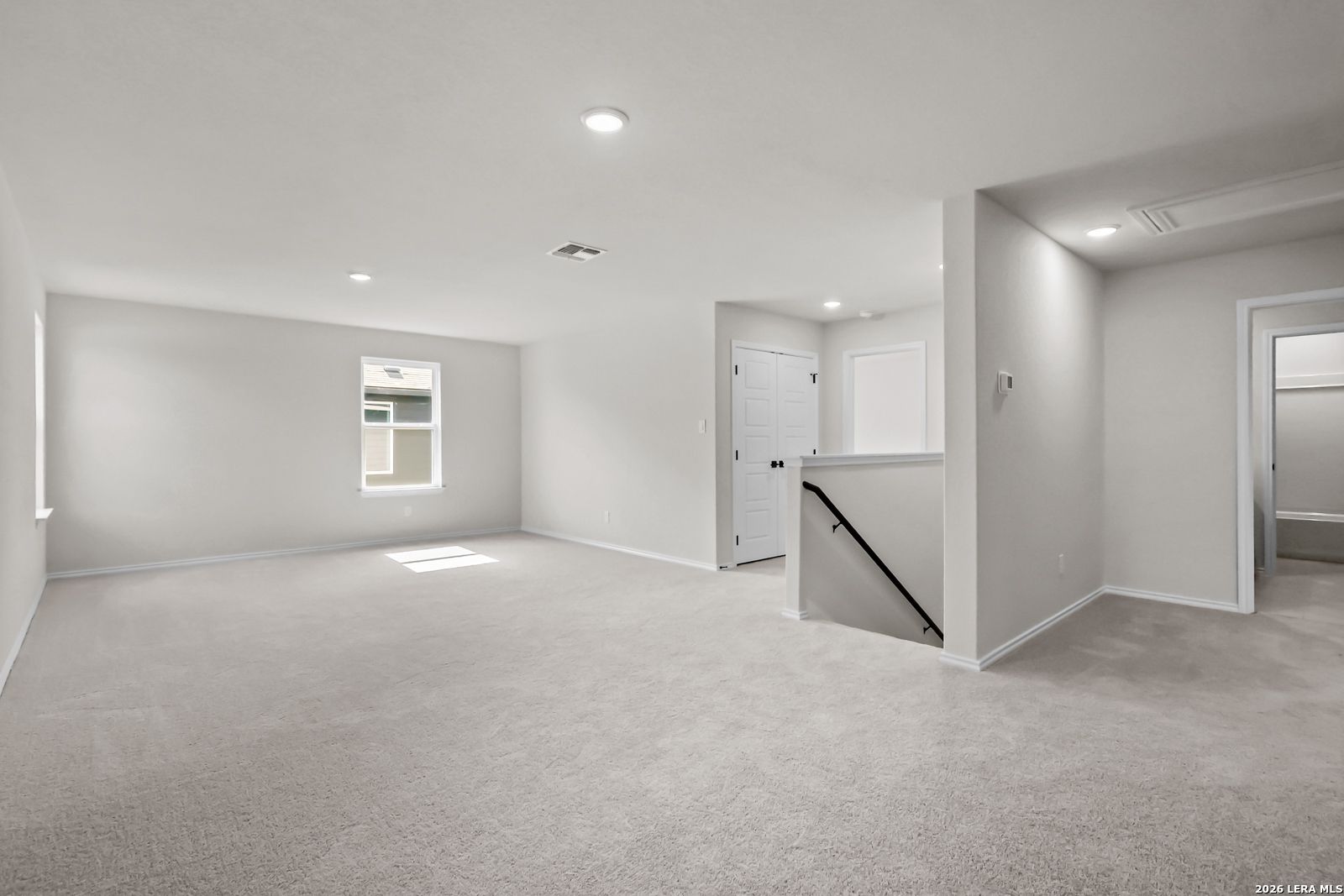 Spacious carpeted game room in The Douglas C floor plan by Davidson Homes in Hannah Heights, Seguin, Texas.