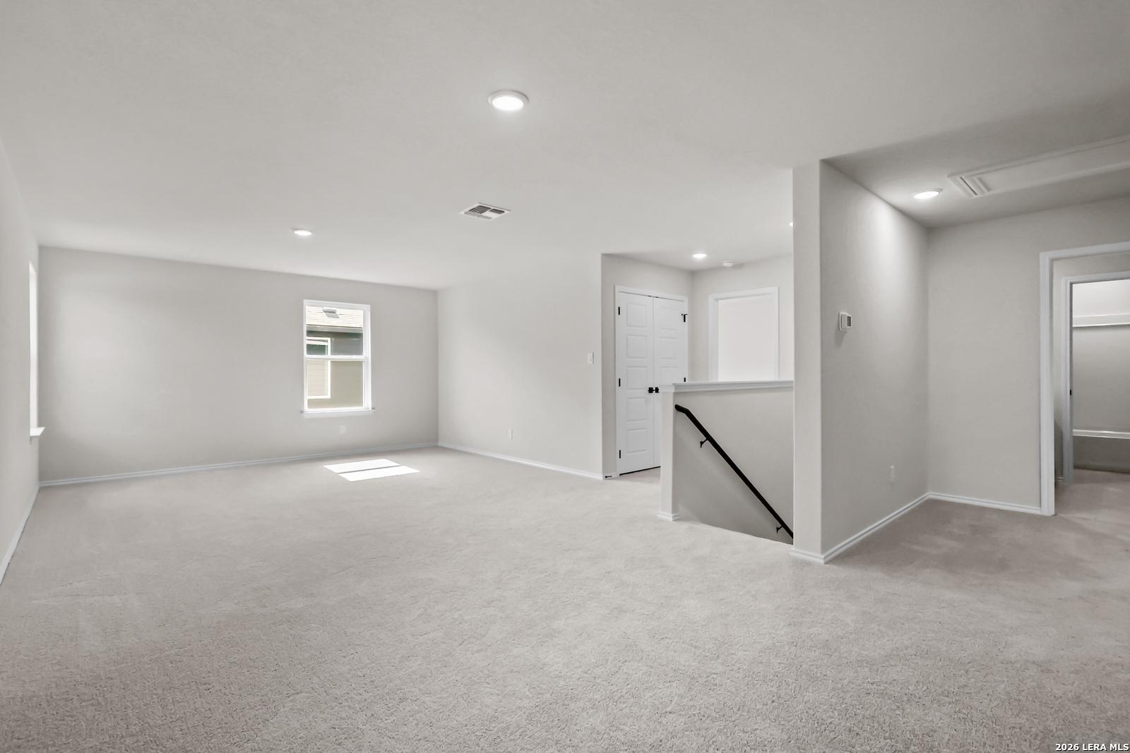 Spacious carpeted game room in The Douglas C floor plan by Davidson Homes in Hannah Heights, Seguin, Texas.