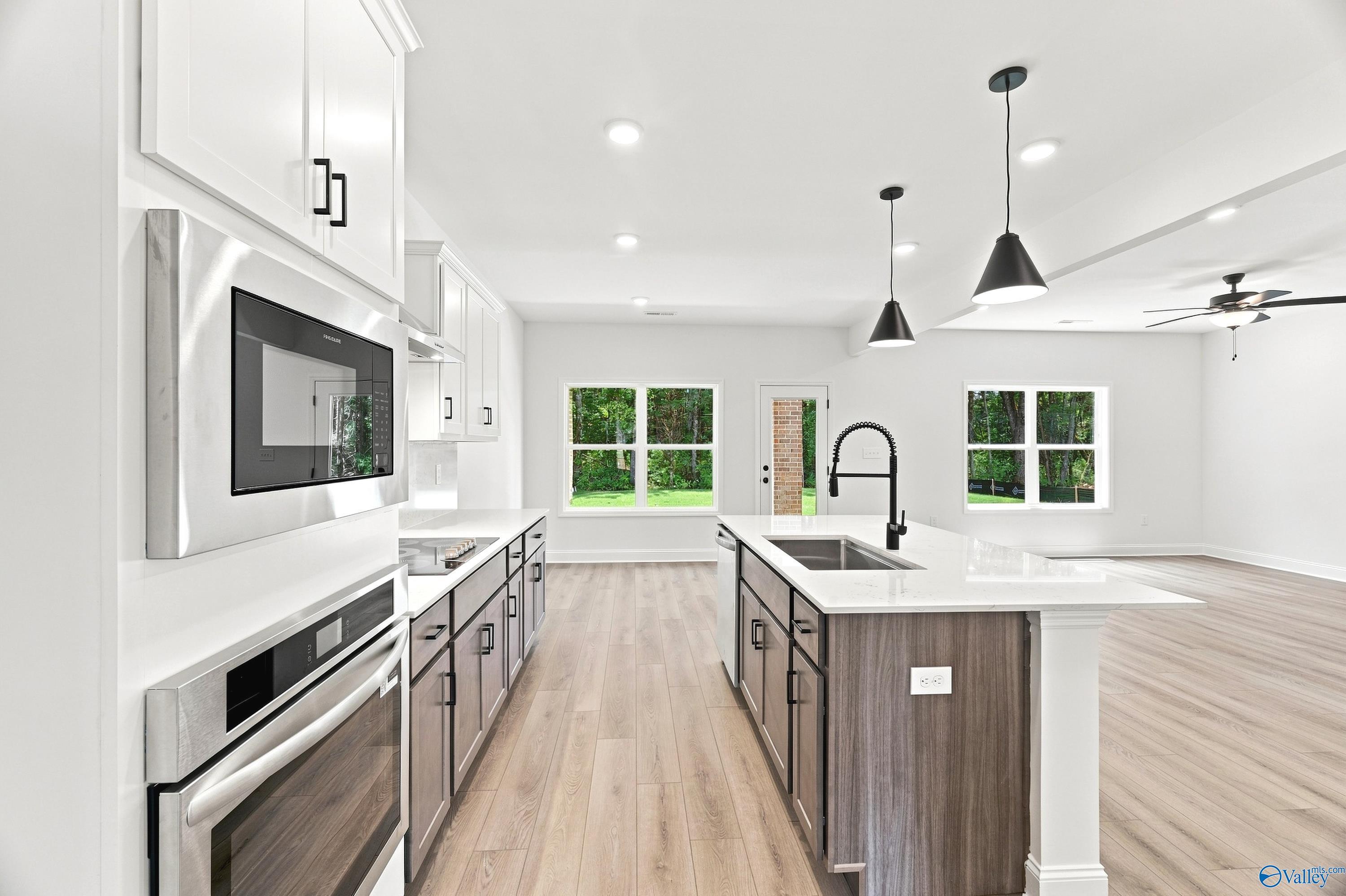 Modern kitchen with center island and stainless appliances in The Shelby B floor plan at Jaguar Hills, Huntsville, Alabama.