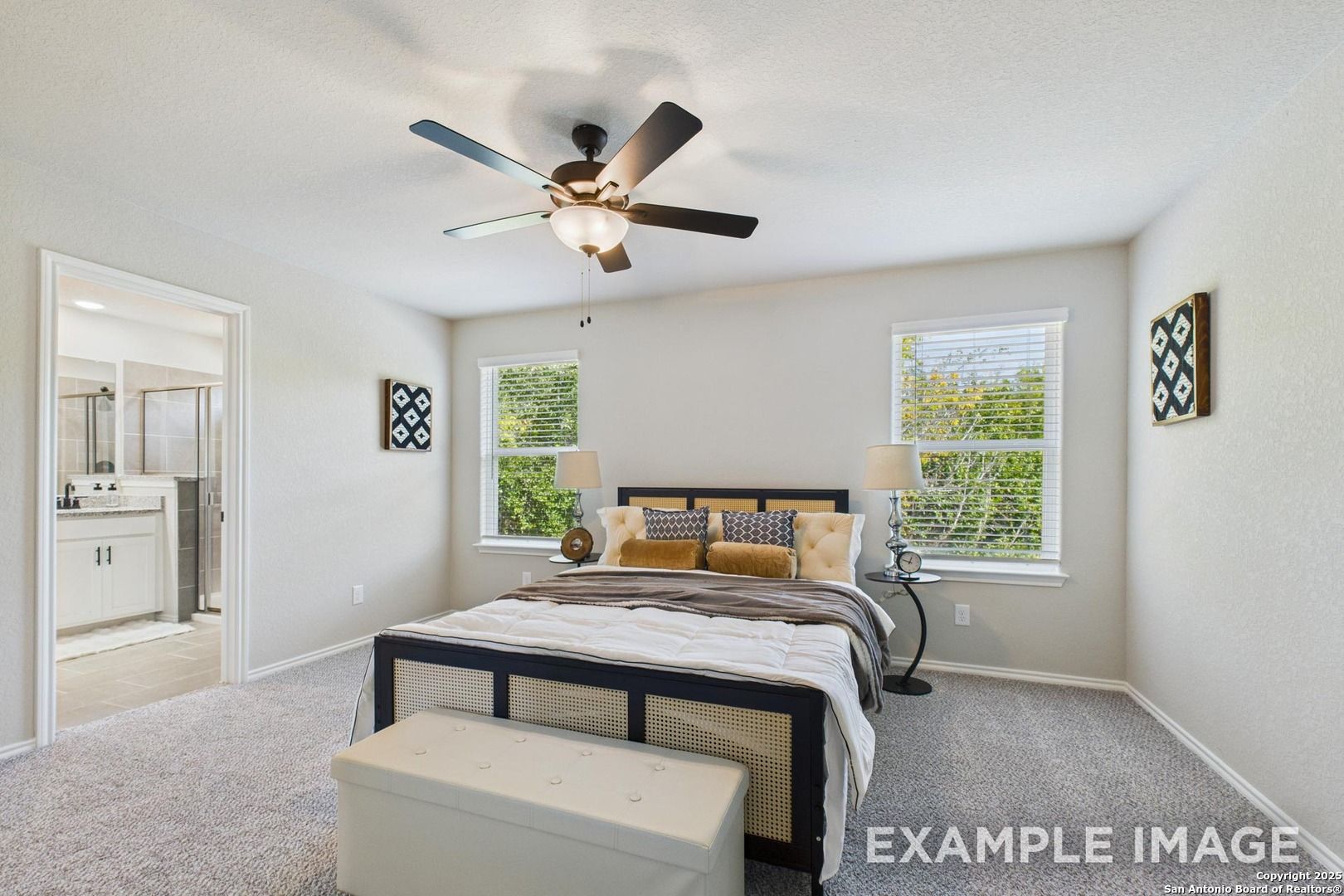 Master bedroom with king bed, ceiling fan, en-suite bath in Davidson Homes The Charlotte A, San Antonio, Texas