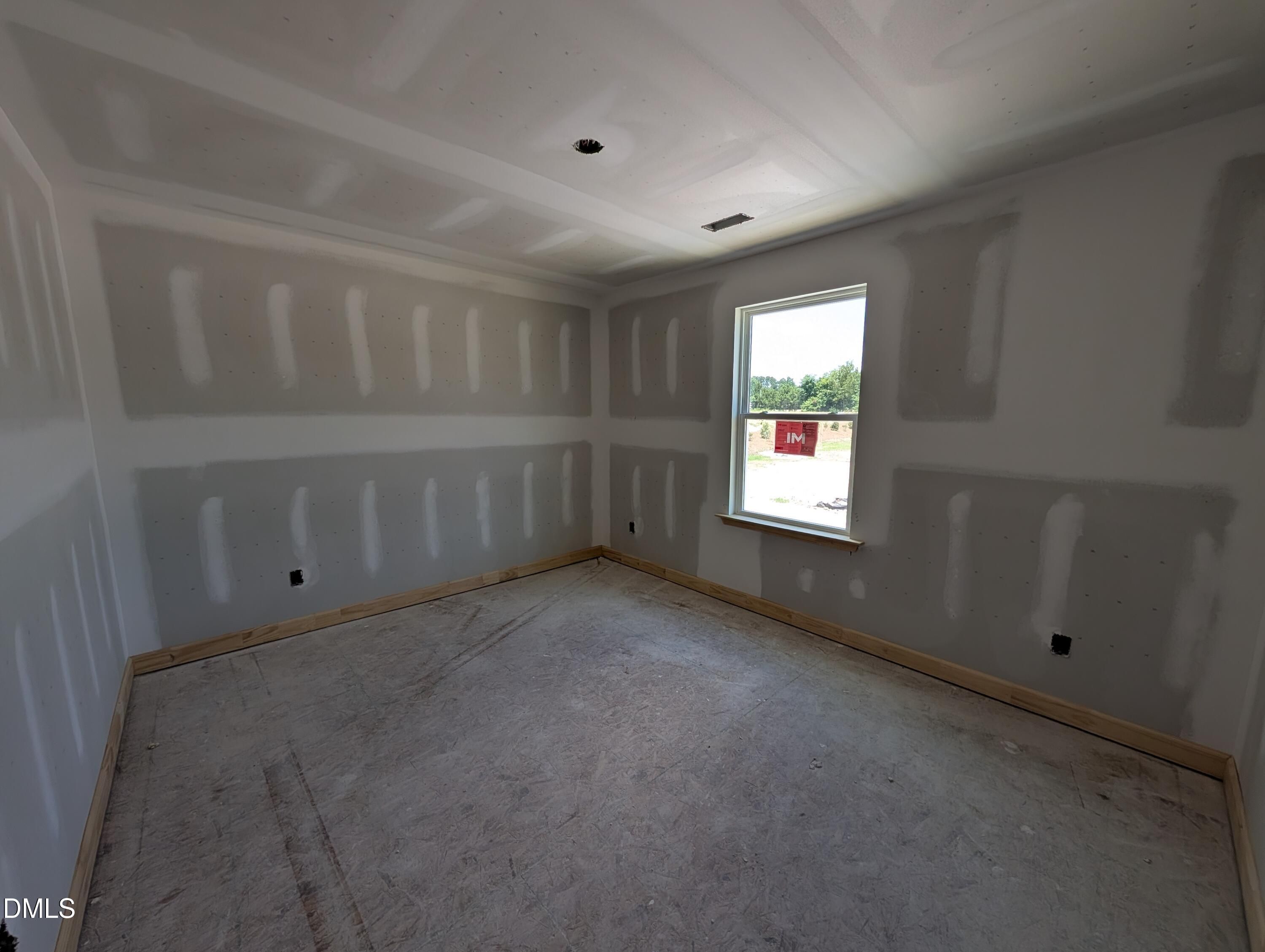 Unfinished bedroom with drywall in The Chestnut floor plan at Wendell Ridge, Wendell, North Carolina by Davidson Homes.