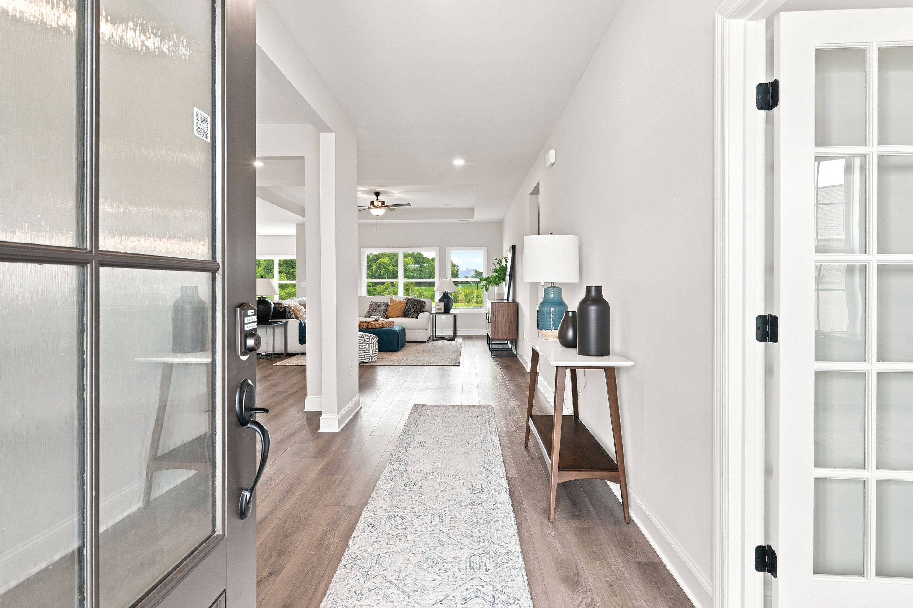 Bright foyer entryway at Riverton Preserve in Huntsville, AL by Davidson Homes with hardwood floors and open floor plan.