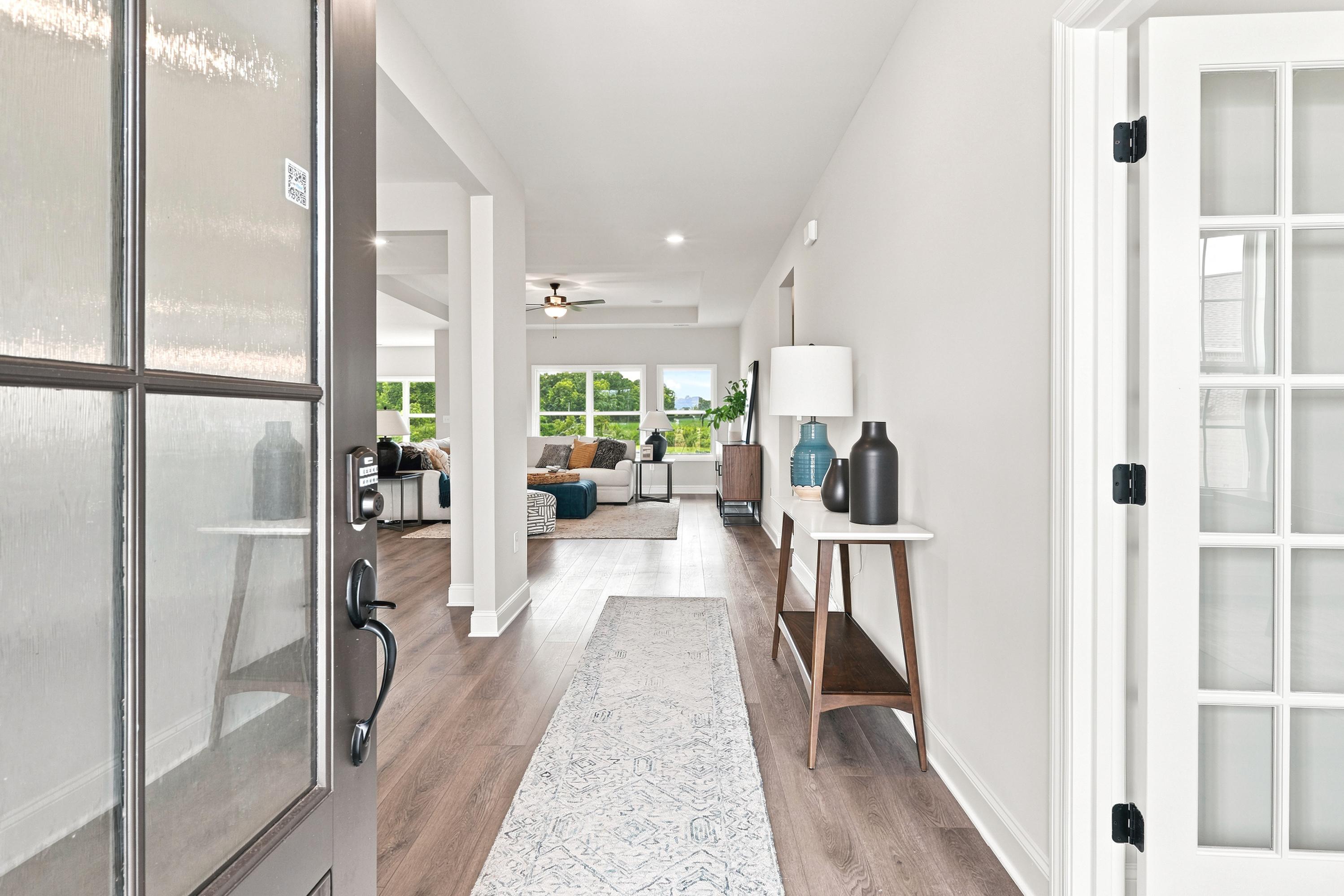 Bright foyer entryway at Riverton Preserve in Huntsville, AL by Davidson Homes with hardwood floors and open floor plan.