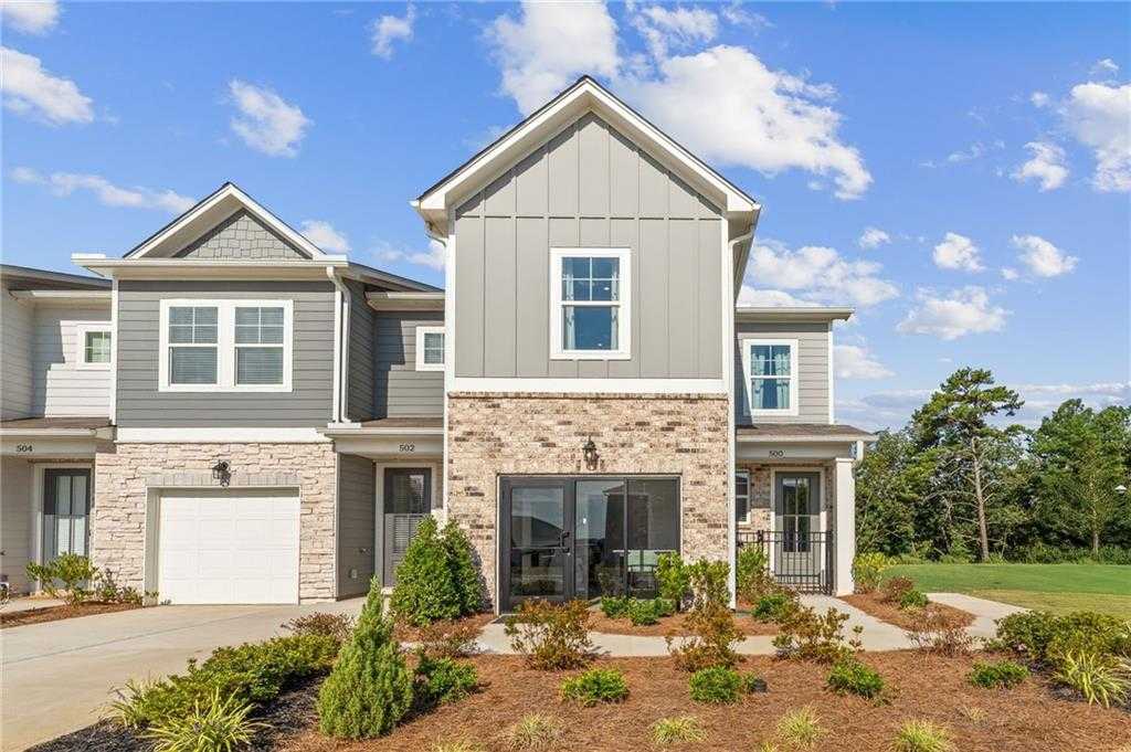 Modern 2-story Wilmington B home by Davidson Homes in Stegall Village, Emerson, GA, with gray siding, brick accents, garage, and landscaped front yard