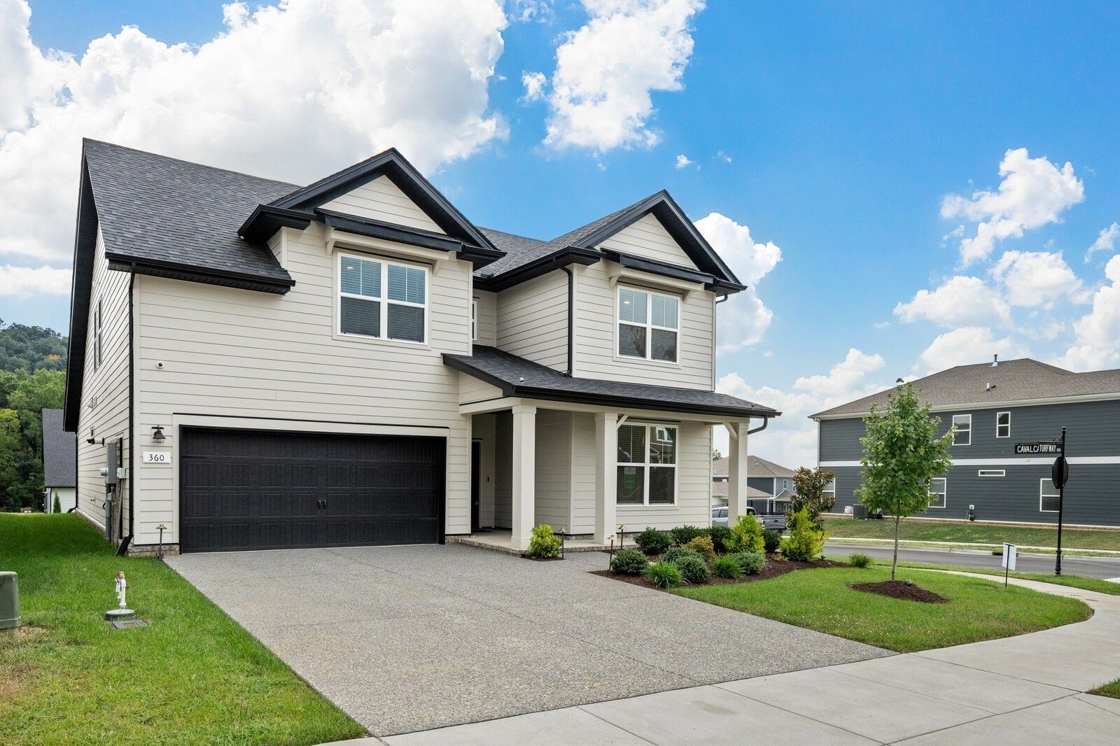 Modern two-story Ridgeport home by Davidson Homes with black-trim siding, two-car garage, and landscaped front yard in Carellton, Gallatin, Tennessee