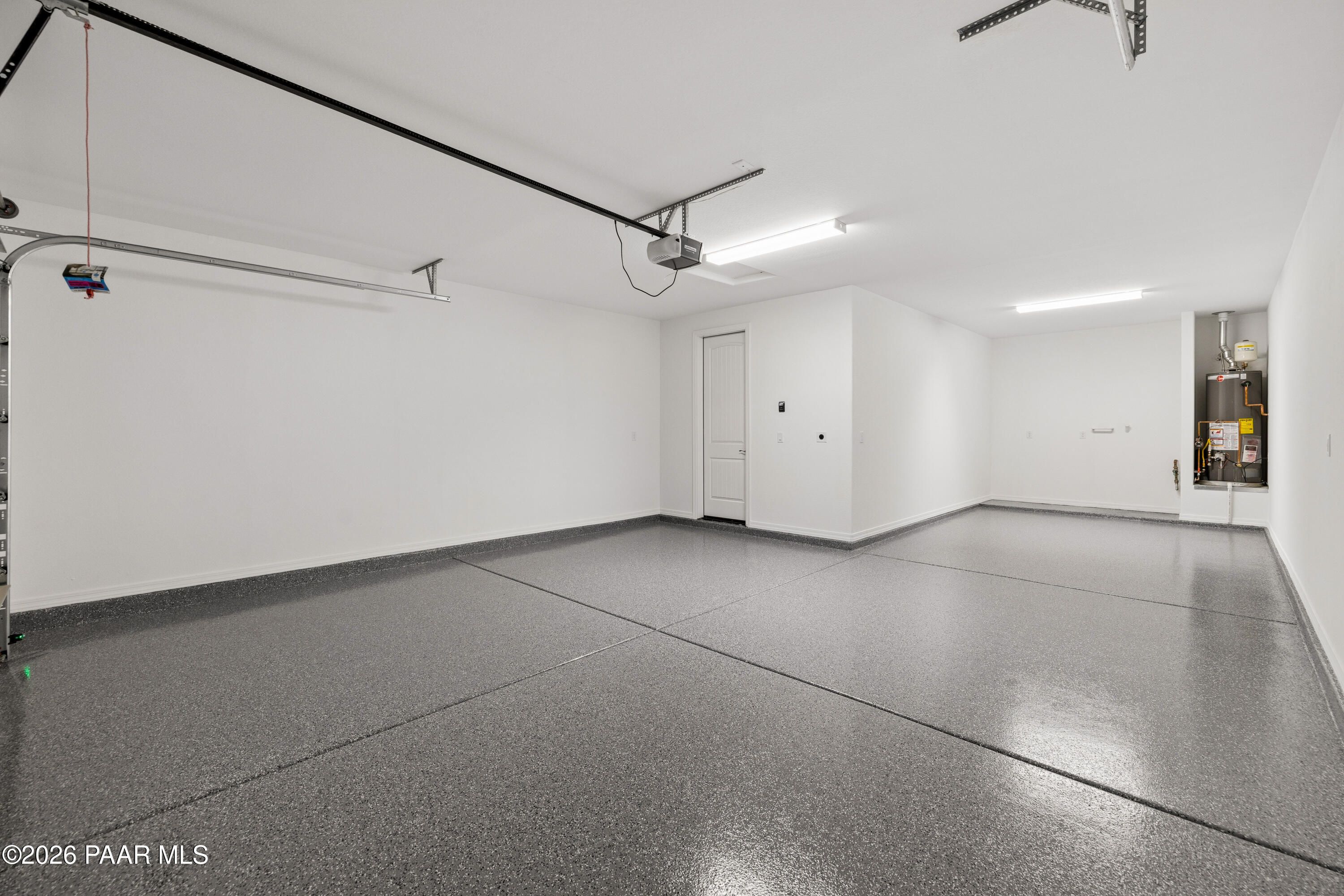 Spacious 3-car garage with epoxy-coated floor in Davidson Homes The Harmony A, Prescott Valley, Arizona